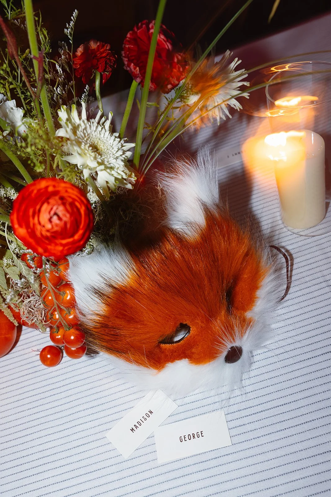 Bride and groom name cards with florals and fox mask