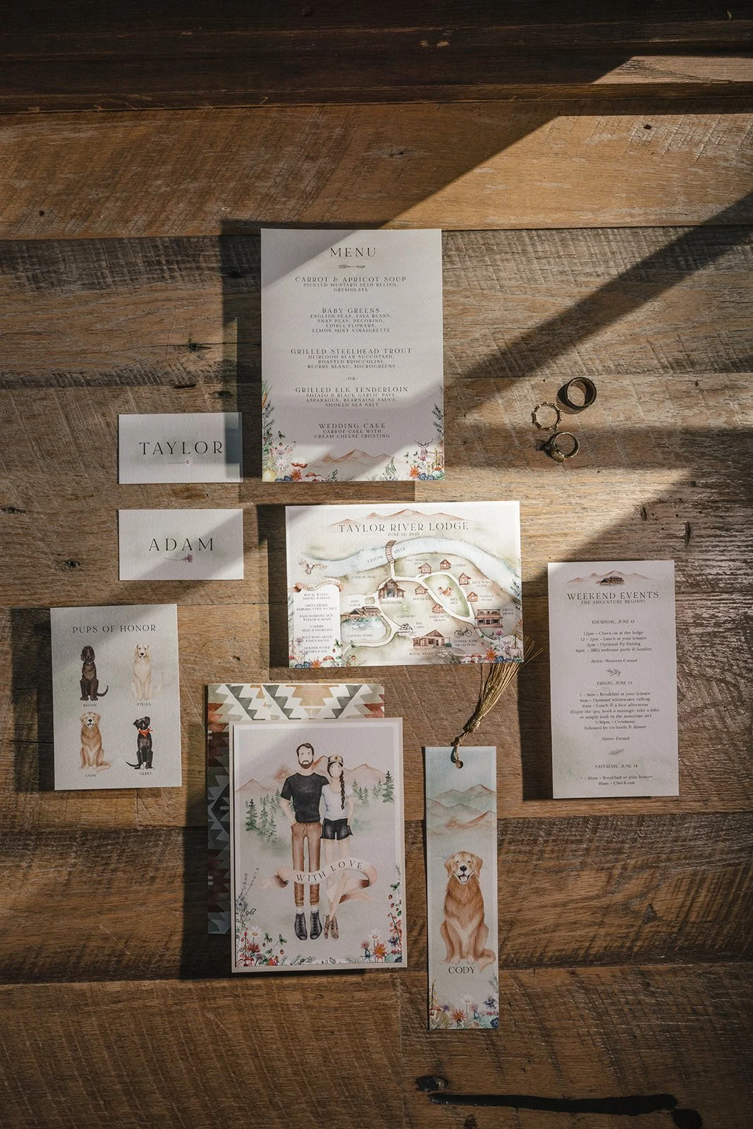 Wedding invitations, place cards, menu and map of venue on wood floor back drop