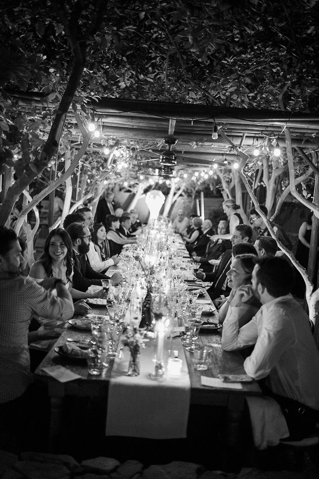 Wedding guests sitting at dinner table eating