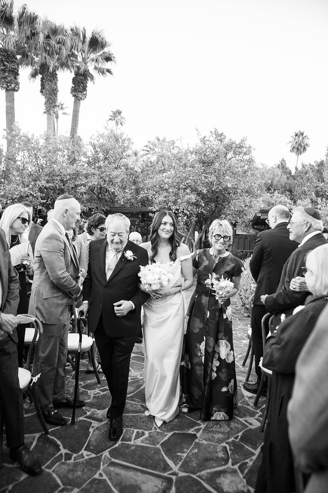 Bride's mother and father walking her down the aisle