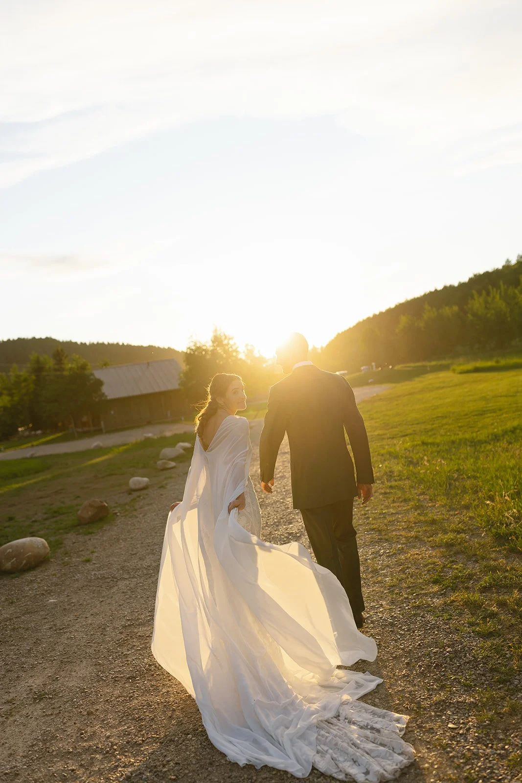 Bride and groom walking away holding hands