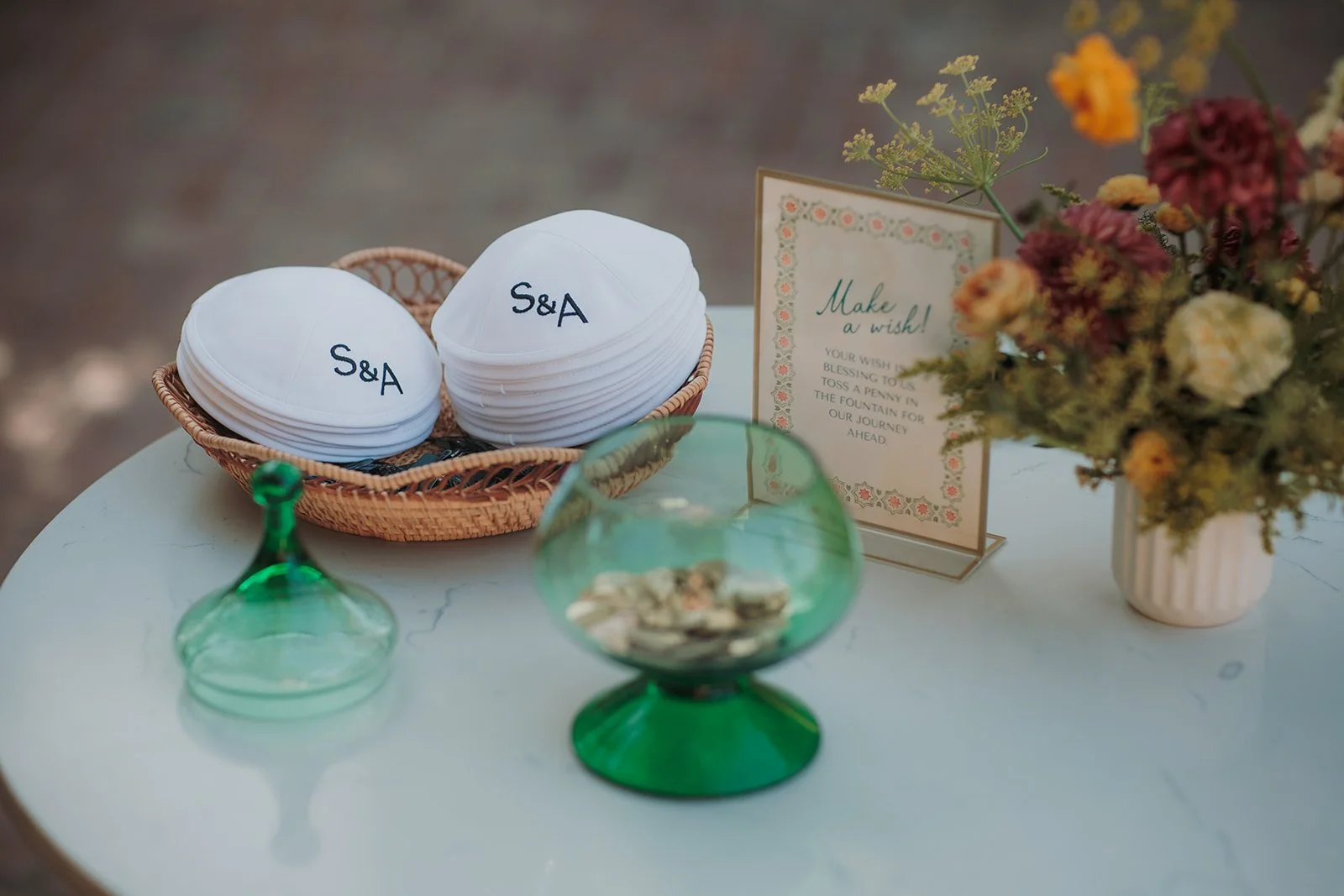 Welcome table for ceremony with custom pennies and kippahs