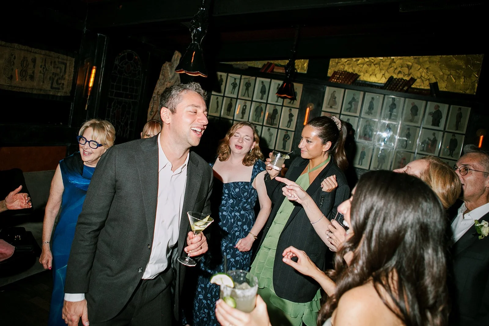 Groom dancing and laughing with guests