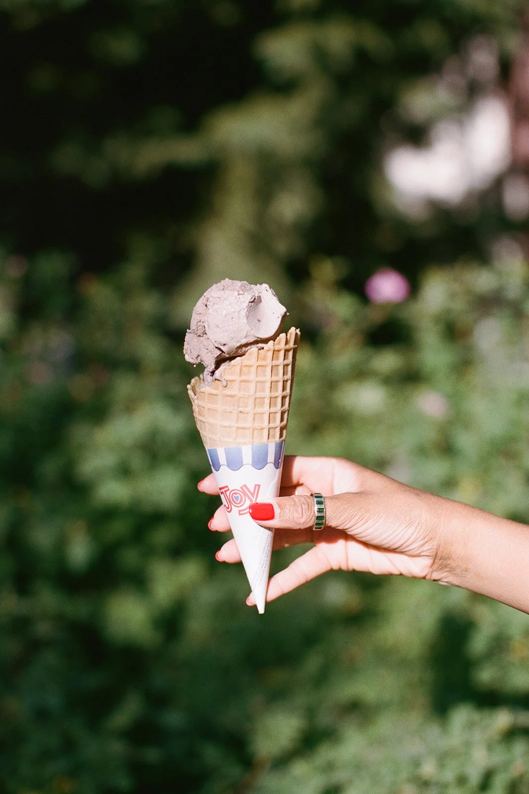 Guest holding ice cream cone in the sun