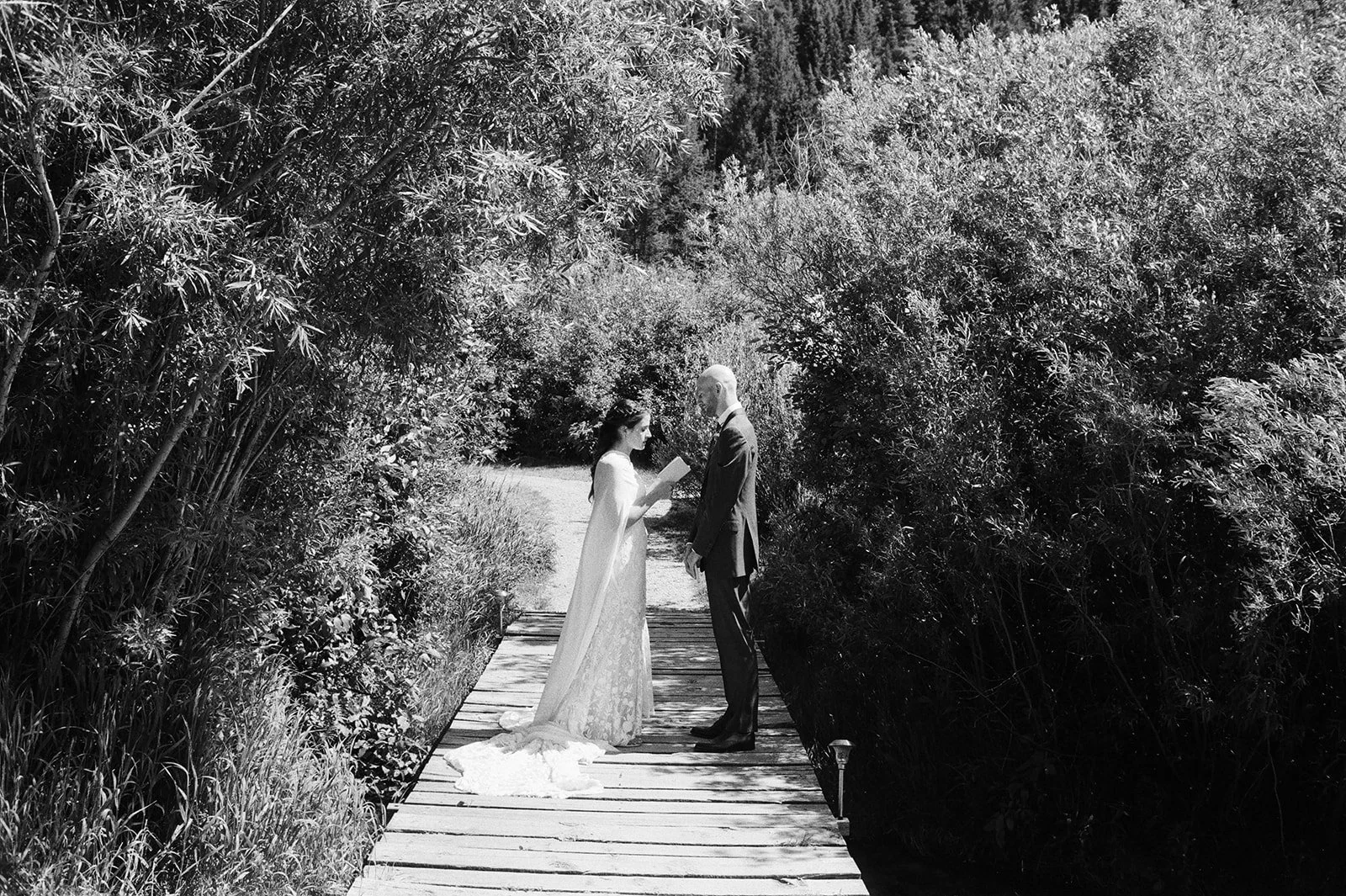 Bride and groom reading vows to each other