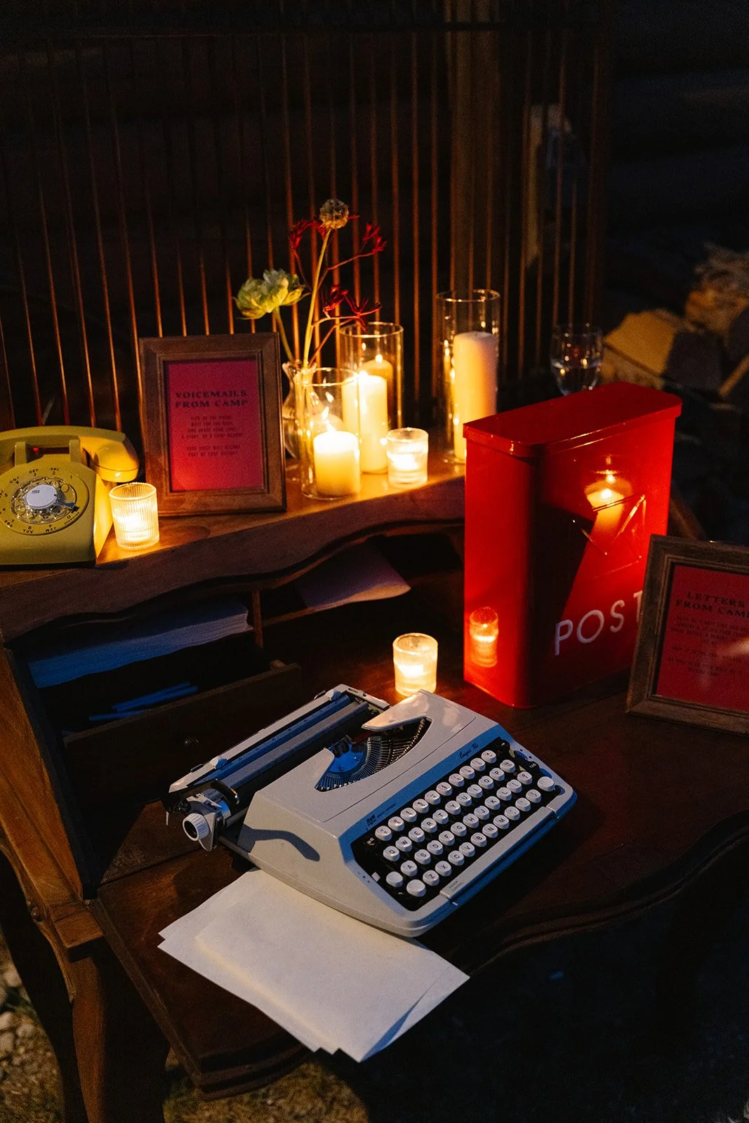 Typewriter in the dark with candles lit around it