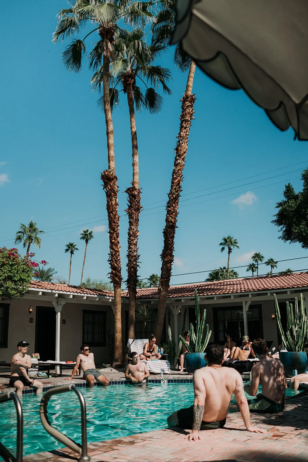Wedding guests lounging by the pool
