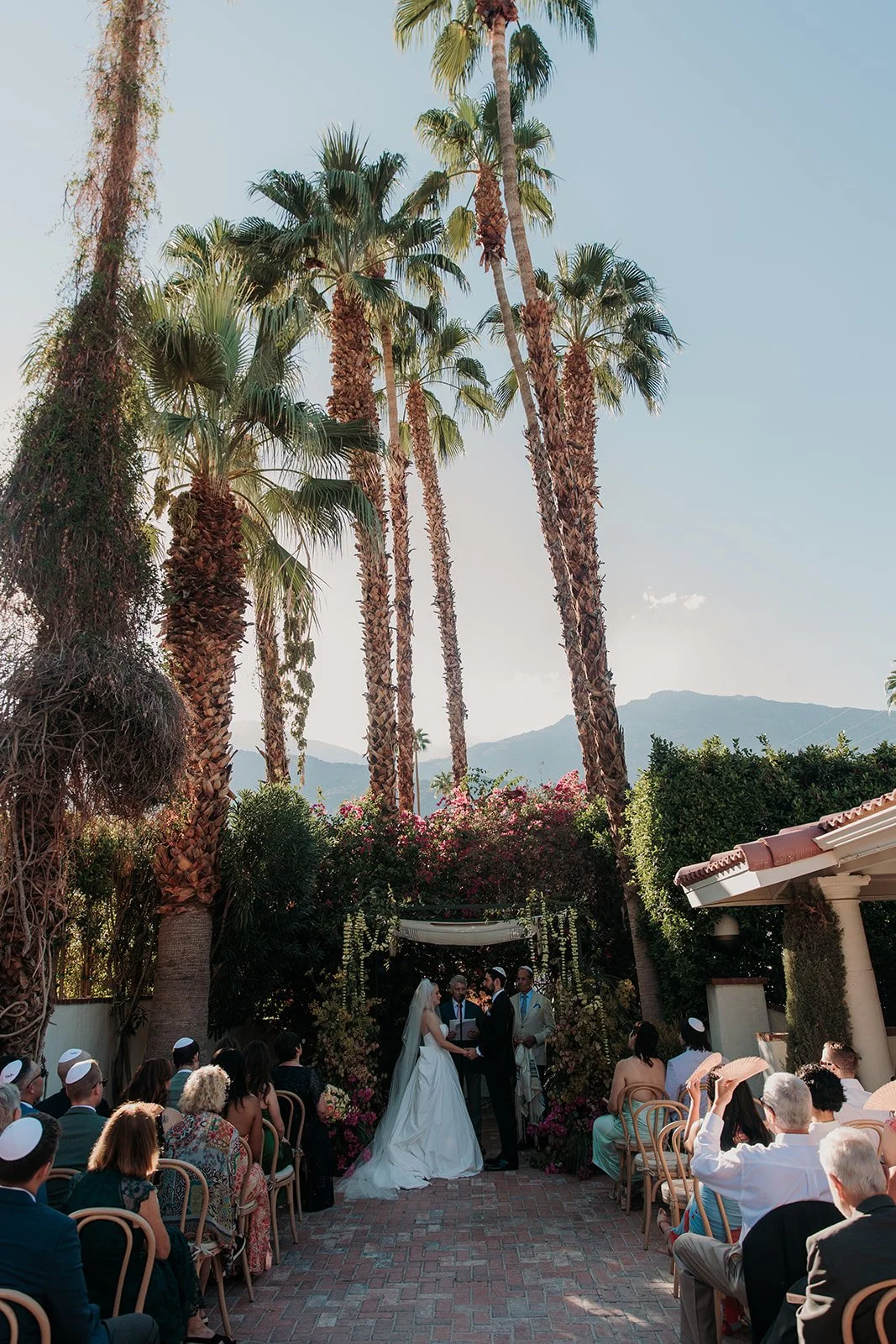 Bride and groom saying vows under chuppah