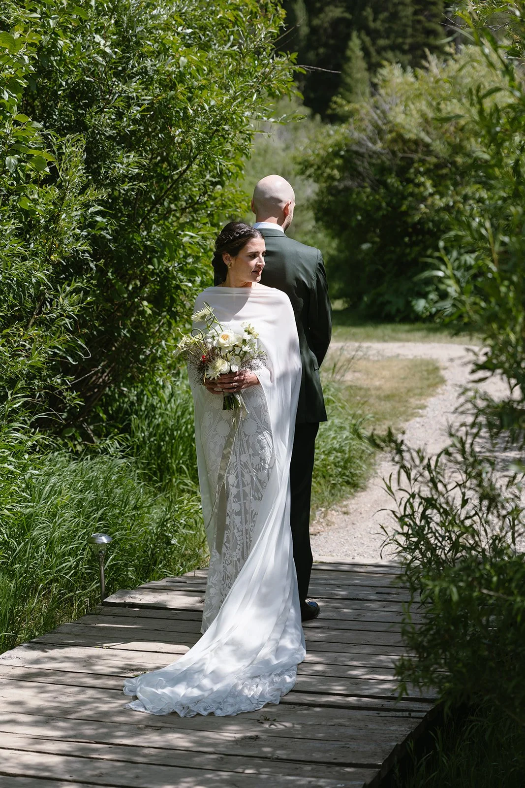 Bride and groom back to back