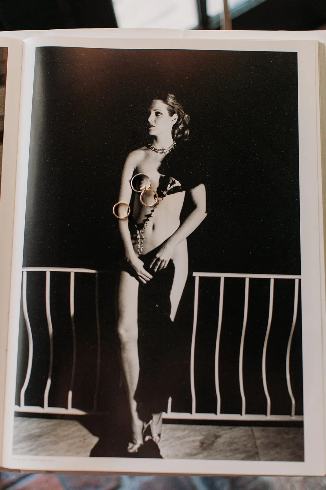 Wedding rings on top of coffee table book