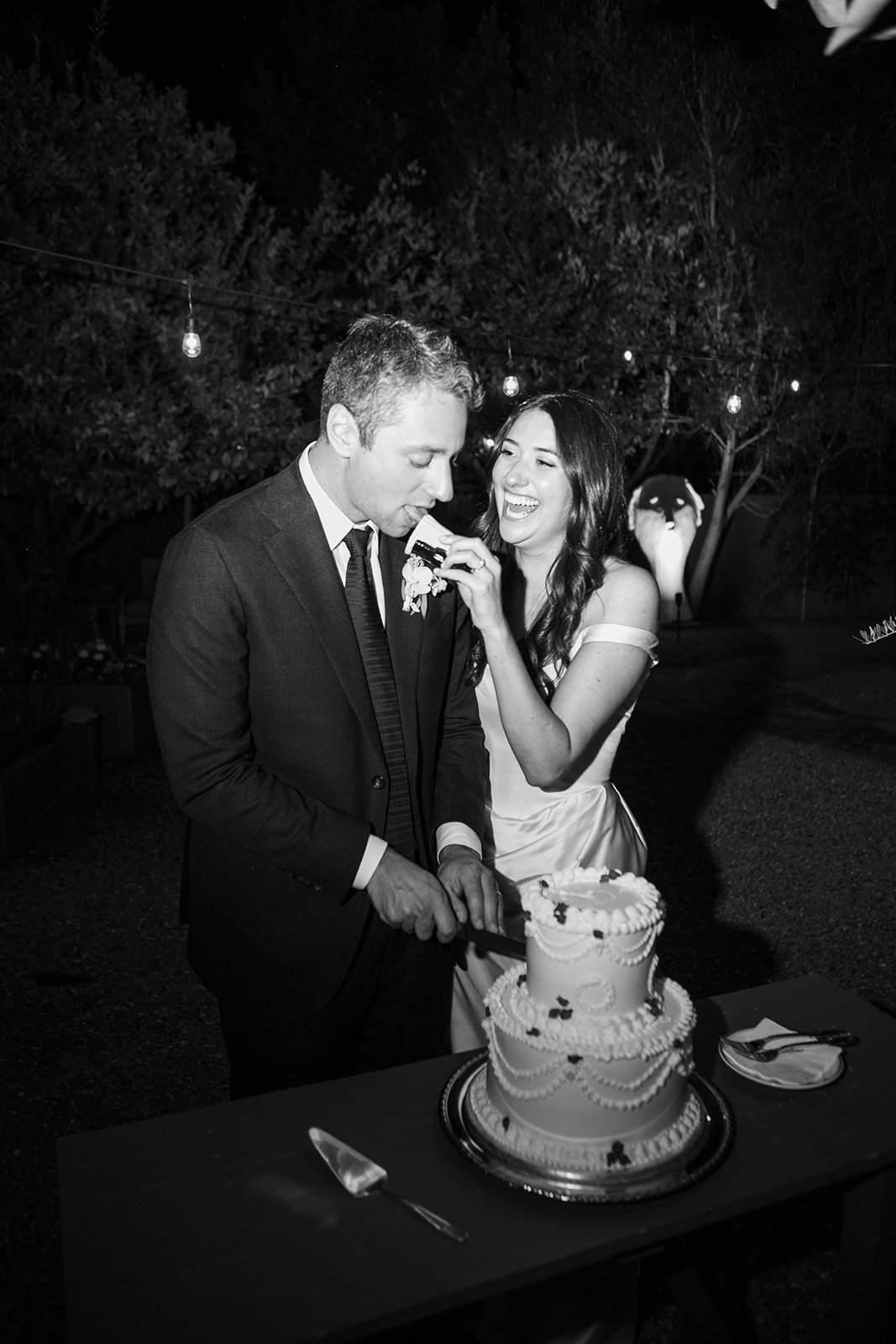 Bride feeding groom cake