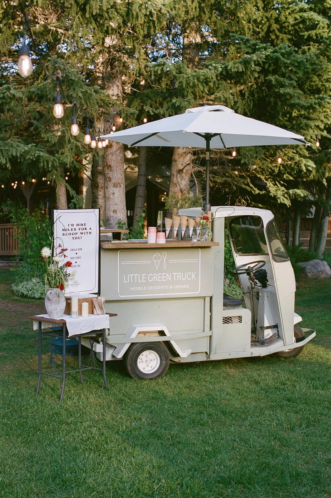 Tiny ice cream truck with custom sign and florals