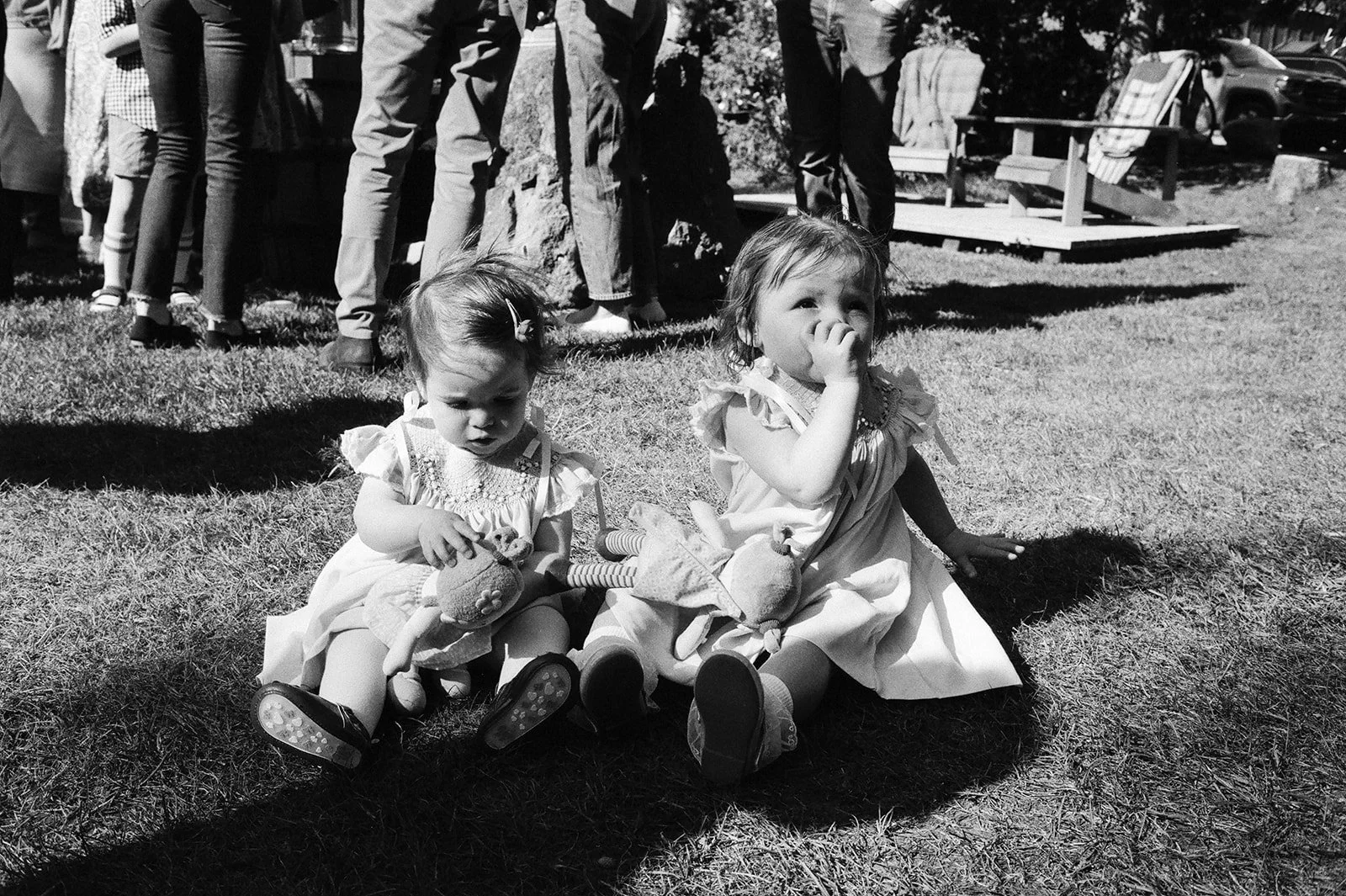 Two kids sitting in grass playing