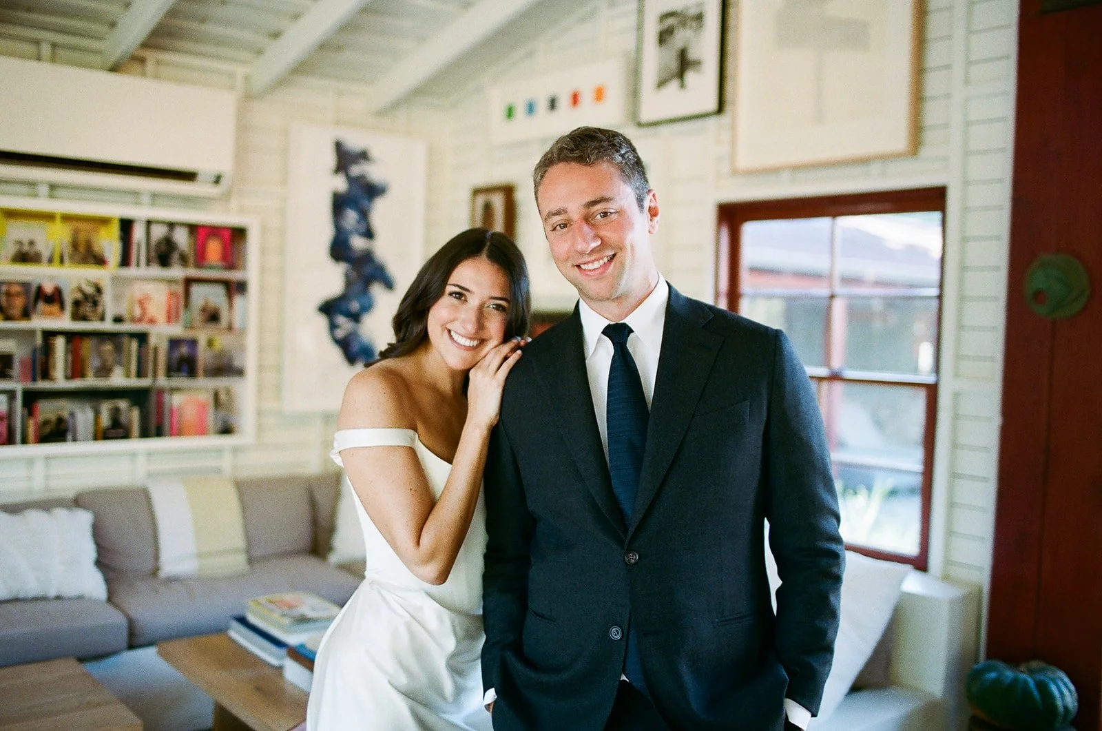 Bride leaning on groom in barn