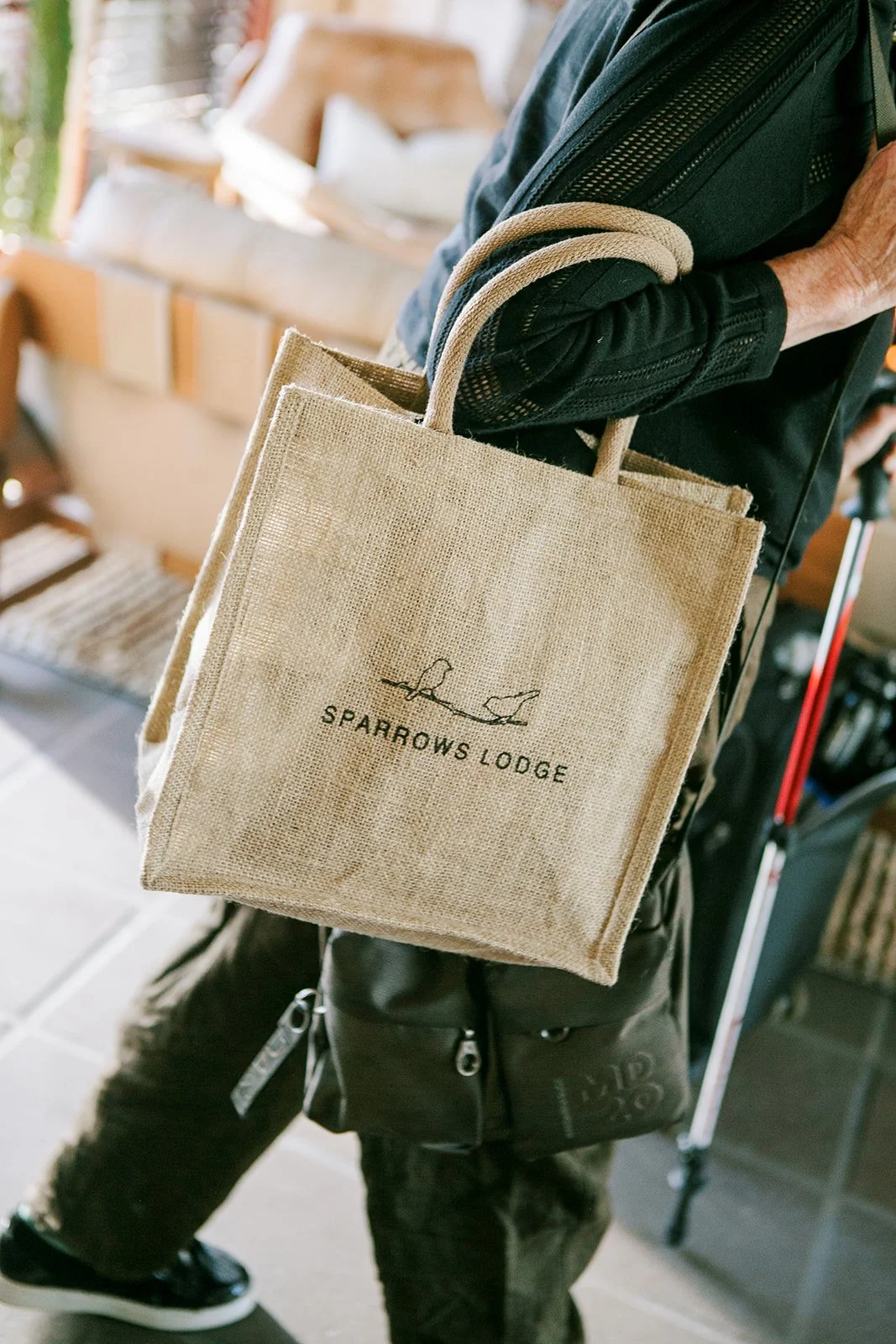 Guest holding Sparrows Lodge tote bag