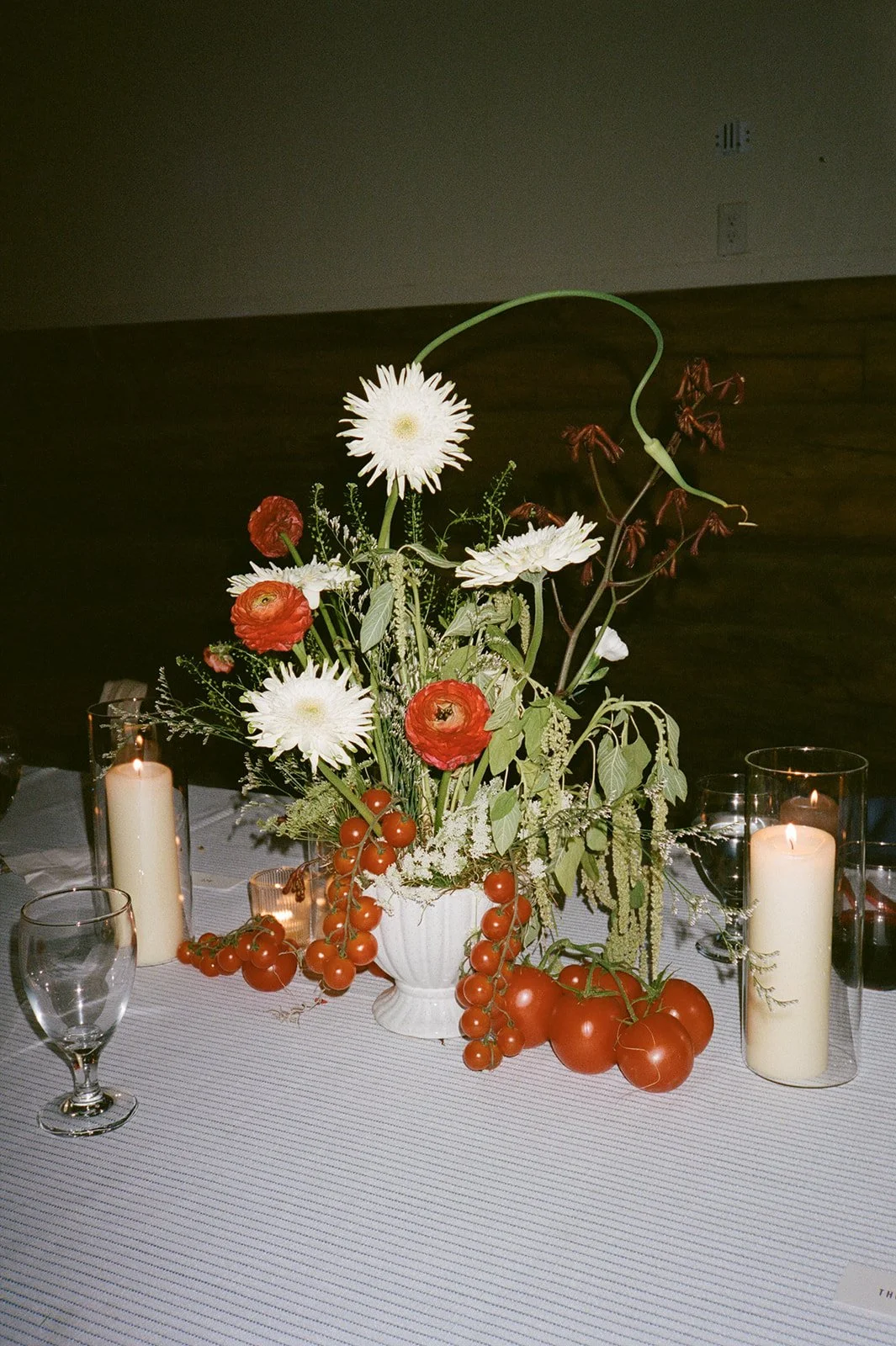 Center piece floral arrangement with green, red, white florals