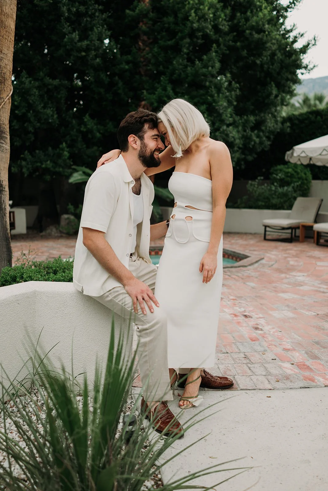 Bride and groom nose to nose in welcome party attire
