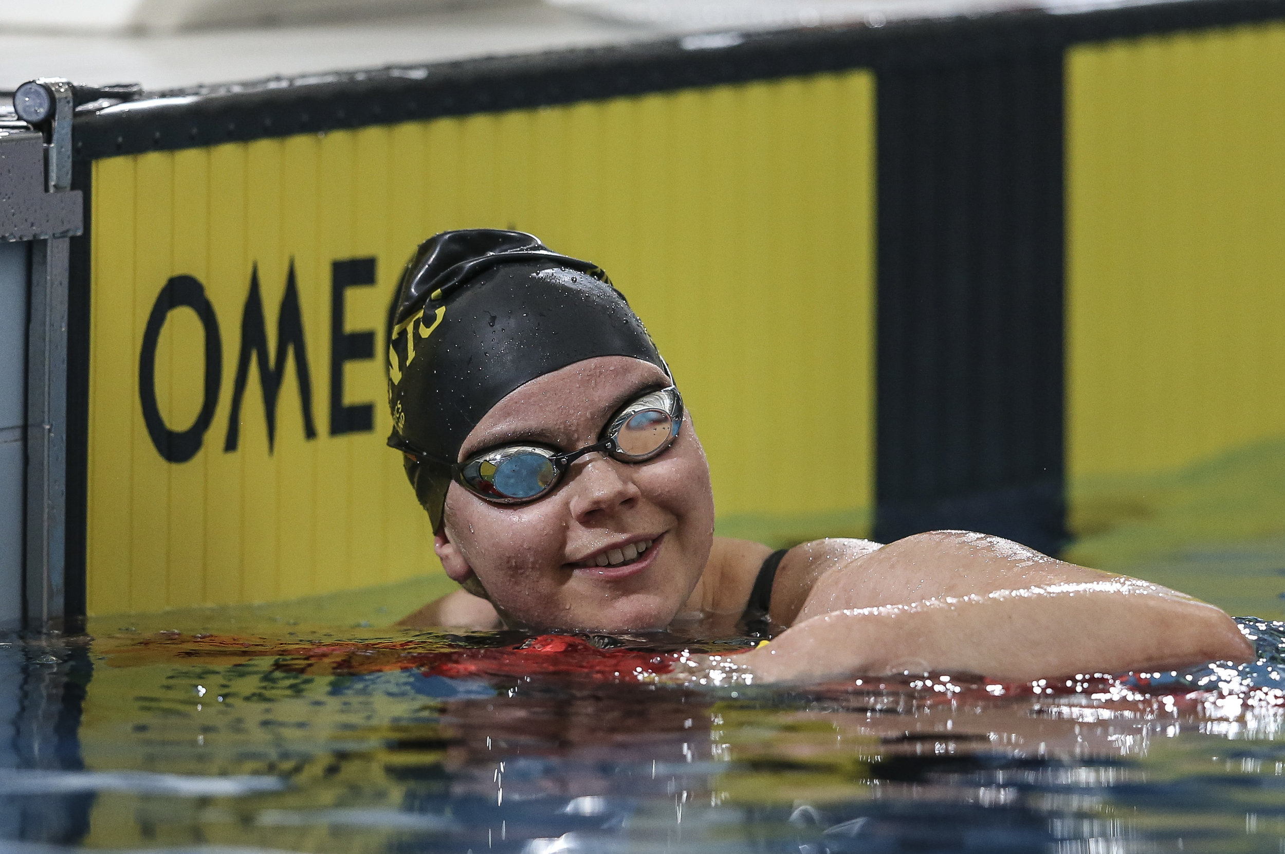 Paralympian Mary Fisher smiling in pool after finishing race