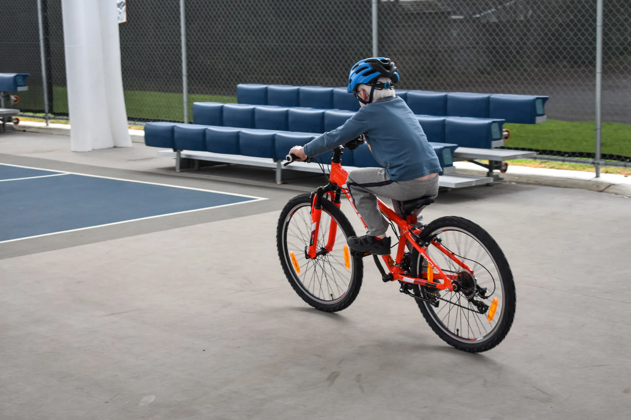 Participant learns new skills during cycling session before riding along the bike track.