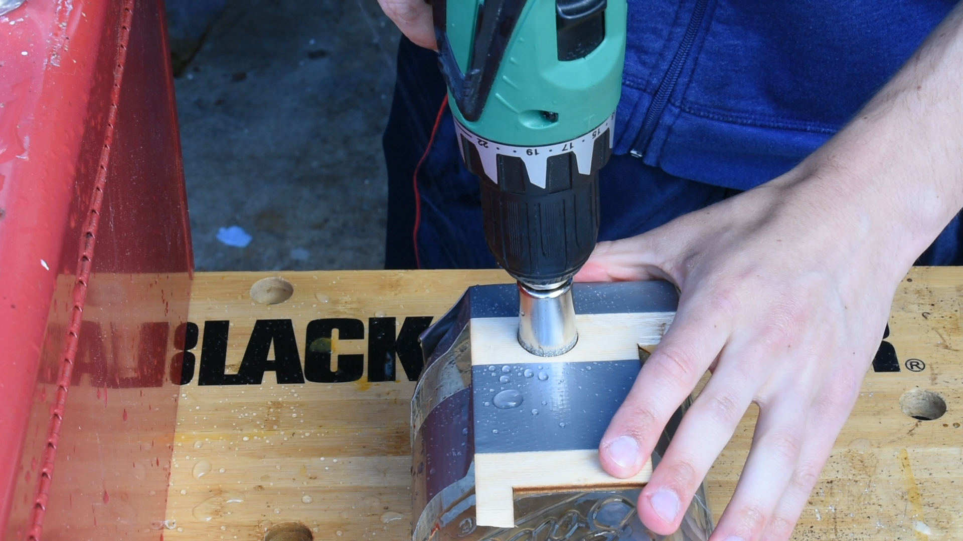 Drilling a hole into one of the glass jars