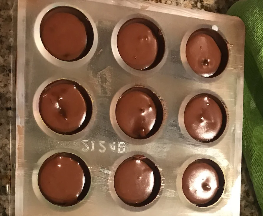 Chocolate-cannabis ganache, poured directly into the decorative chocolate molds.