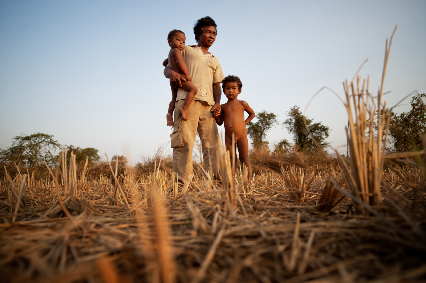  A farmer stands on the land that used to belong to him before a sugar company land grabbed the domain / Cambodia 