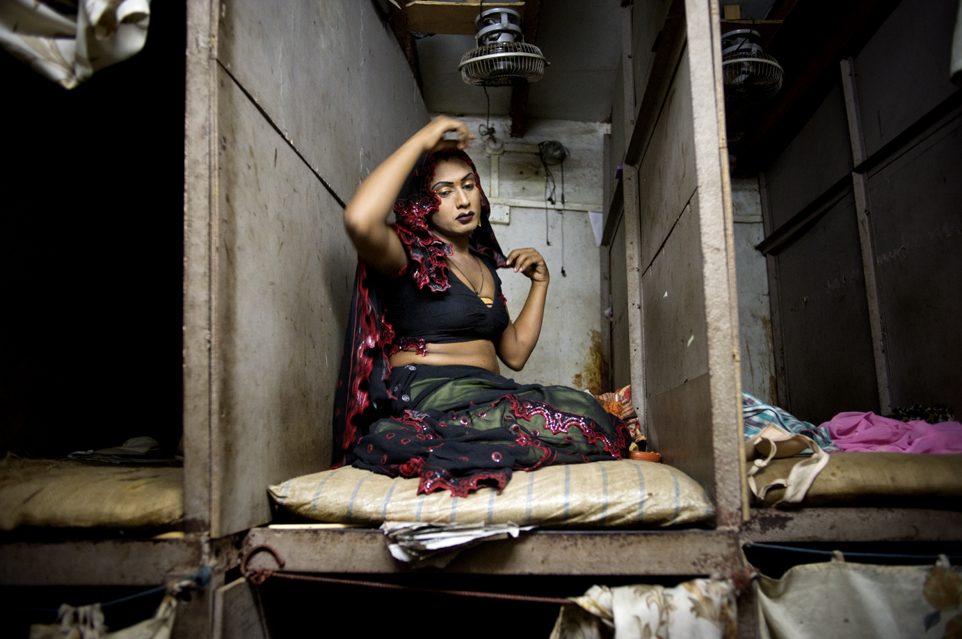  A transgender sex-worker in the cubicle where she/he sells sex from, in Mumbai's red-light districts, Kamathipura / India - 2011 