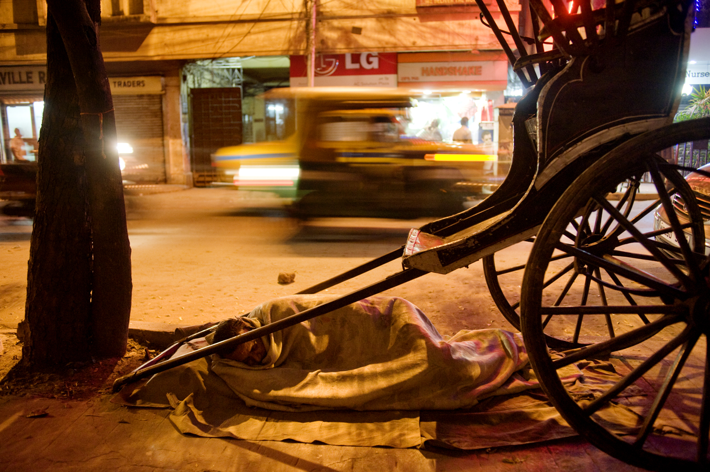  Rickshaw puller sleeping at the street, Calcutta / India  