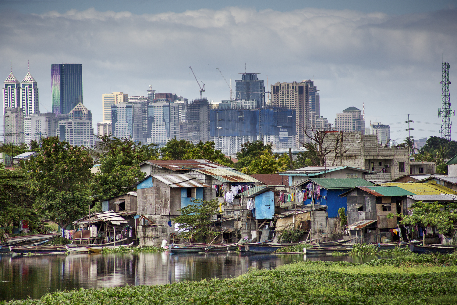  Slum with Manila skyline in the backdrop / Philippines- 2016 