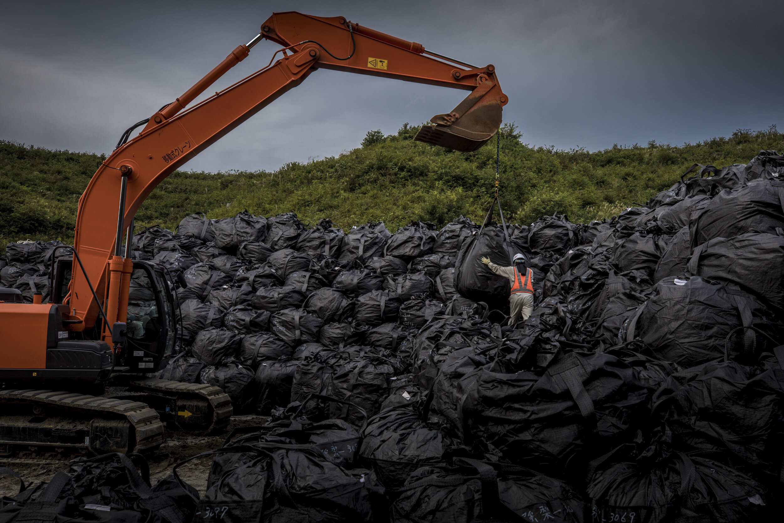  A crane stack sacks containing radioactive soil that has been decontaminated from the ground around Fukushima / Japan -2019 