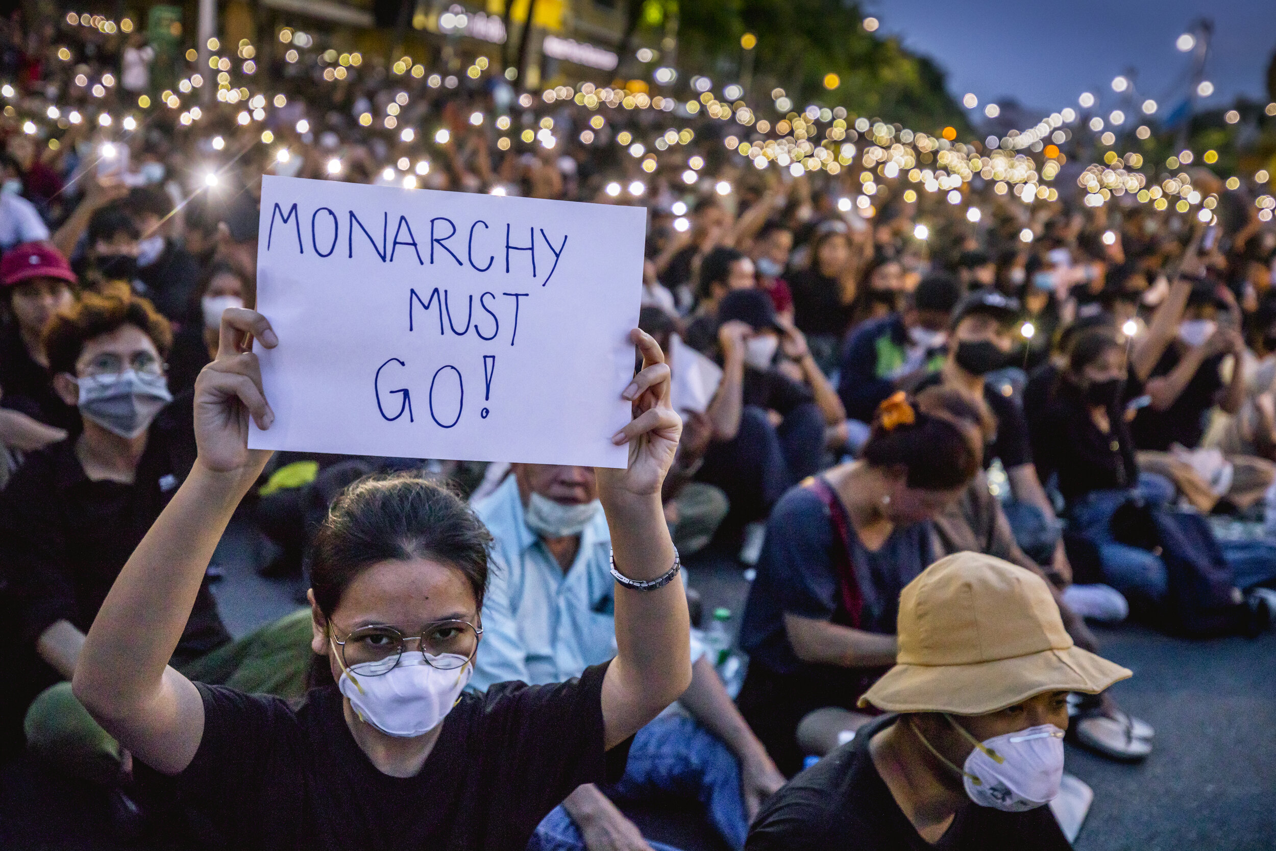  A protester holds up a sign with criticism against the monarchy under a protest in Bangkok/ Thailand- 2020 