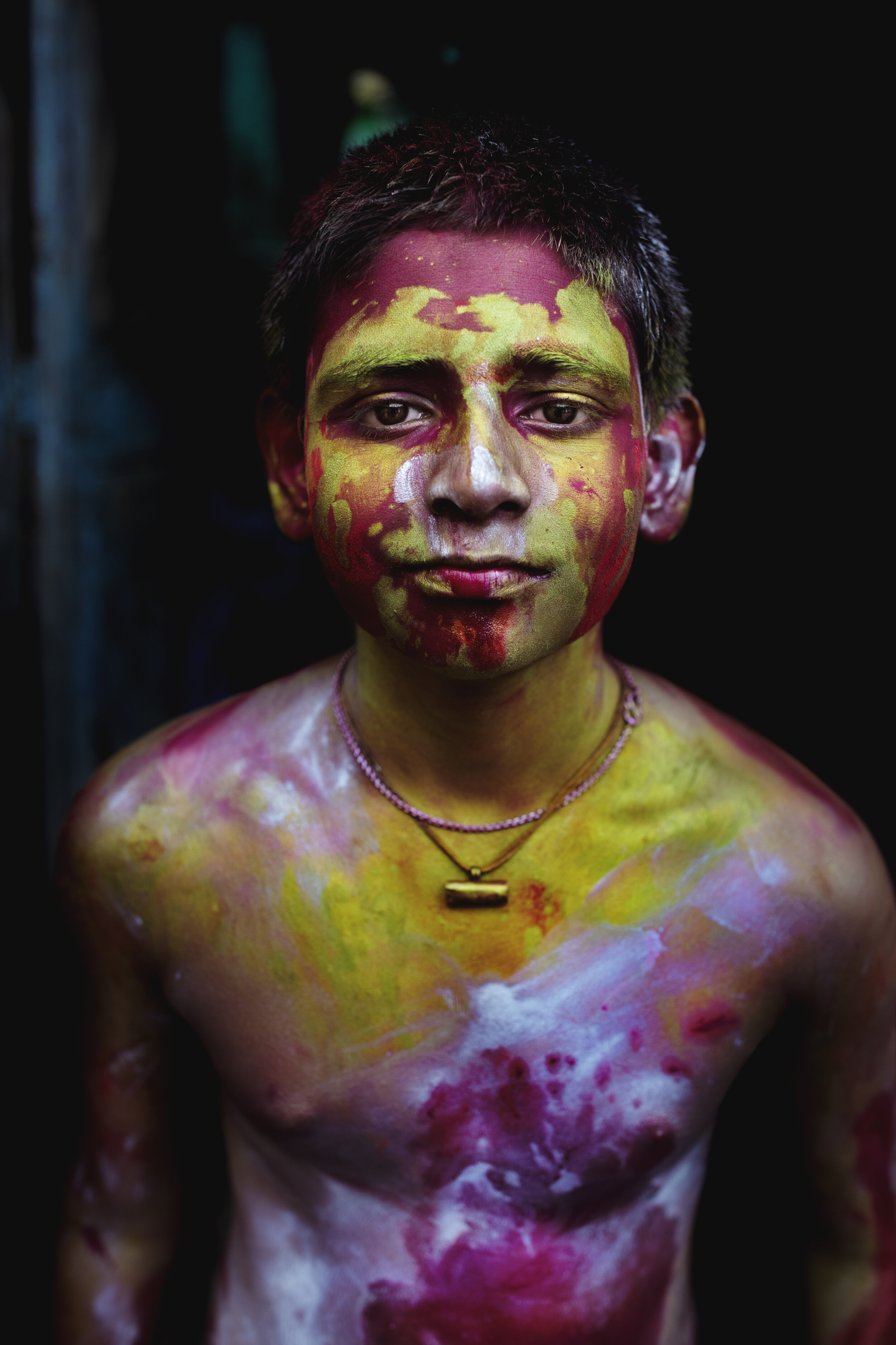  A boy's body is filled with color during the Indian festival Holi / India. 