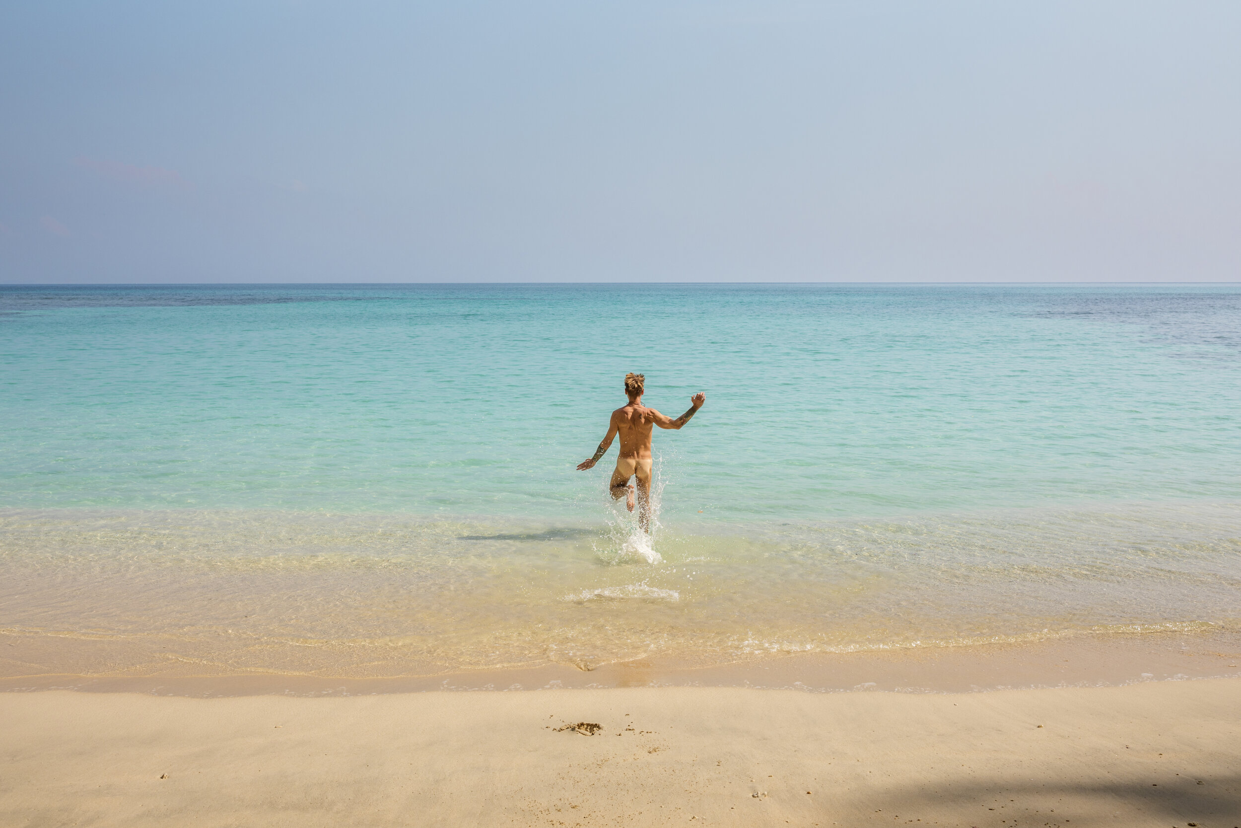 A nudist swimmer at the beach at Havelock Island, Andaman / India. 