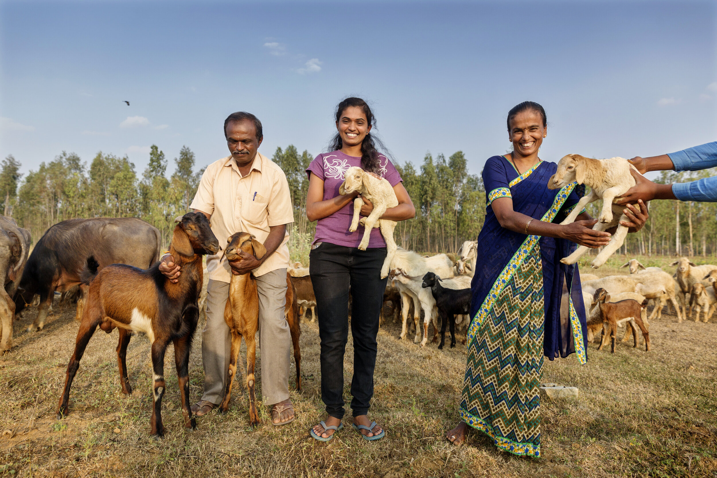  Aruna and her parents on the family's farmland. Aruna became the first person from the village to get a job and leave the traditional lifestyle. 