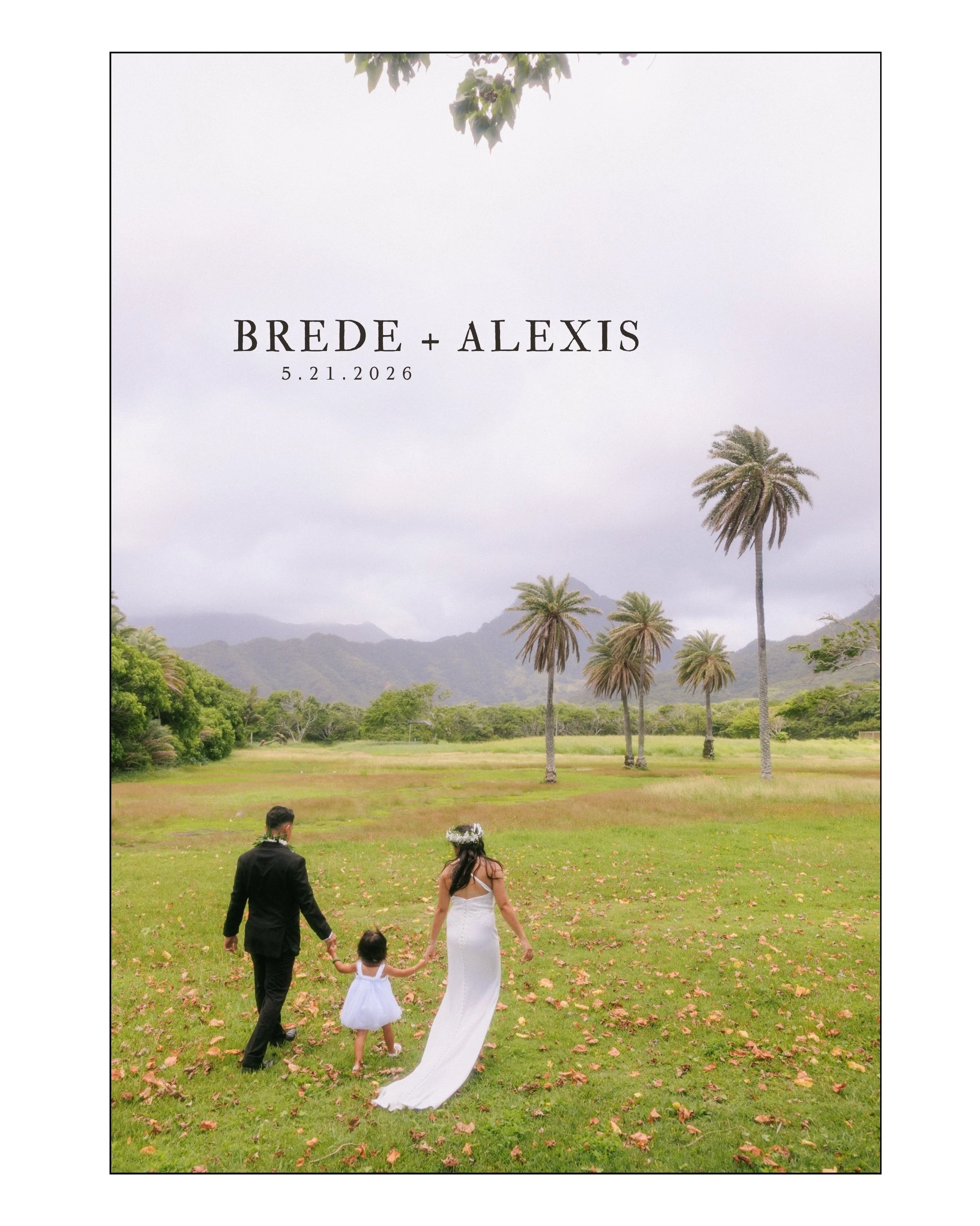 Bride and groom walking hand in hand with their daughter through Kualoa Regional Park during a sunny Oahu elopement with Koʻolau Mountains and palm trees in the background.