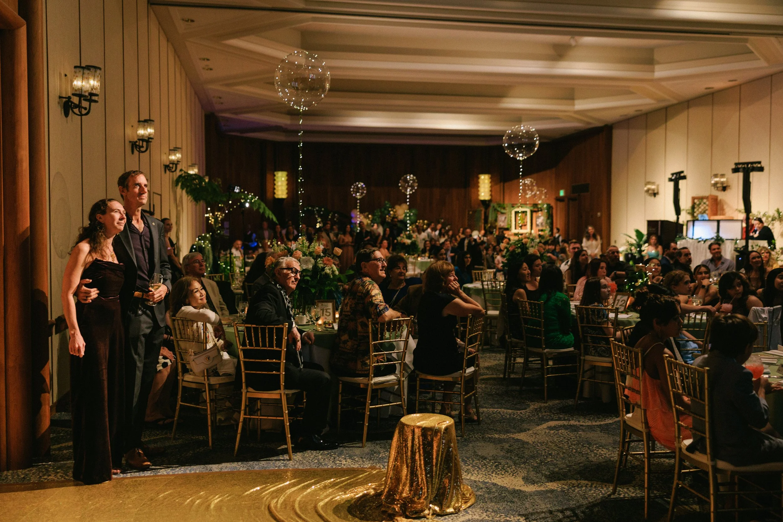 Parents celebrating with their daughter at a bat mitzvah reception in Waikiki