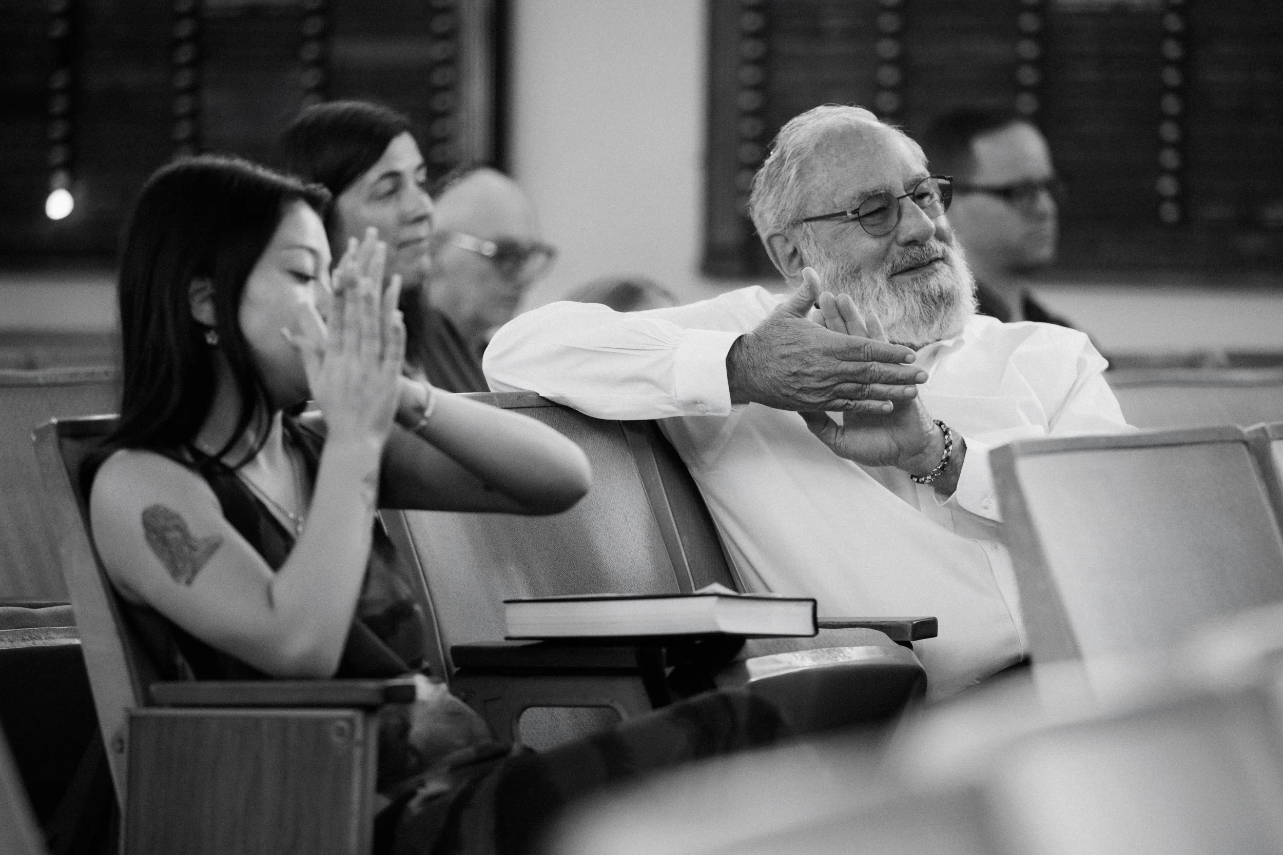 Family watching bar mitzvah ceremony in Honolulu synagogue