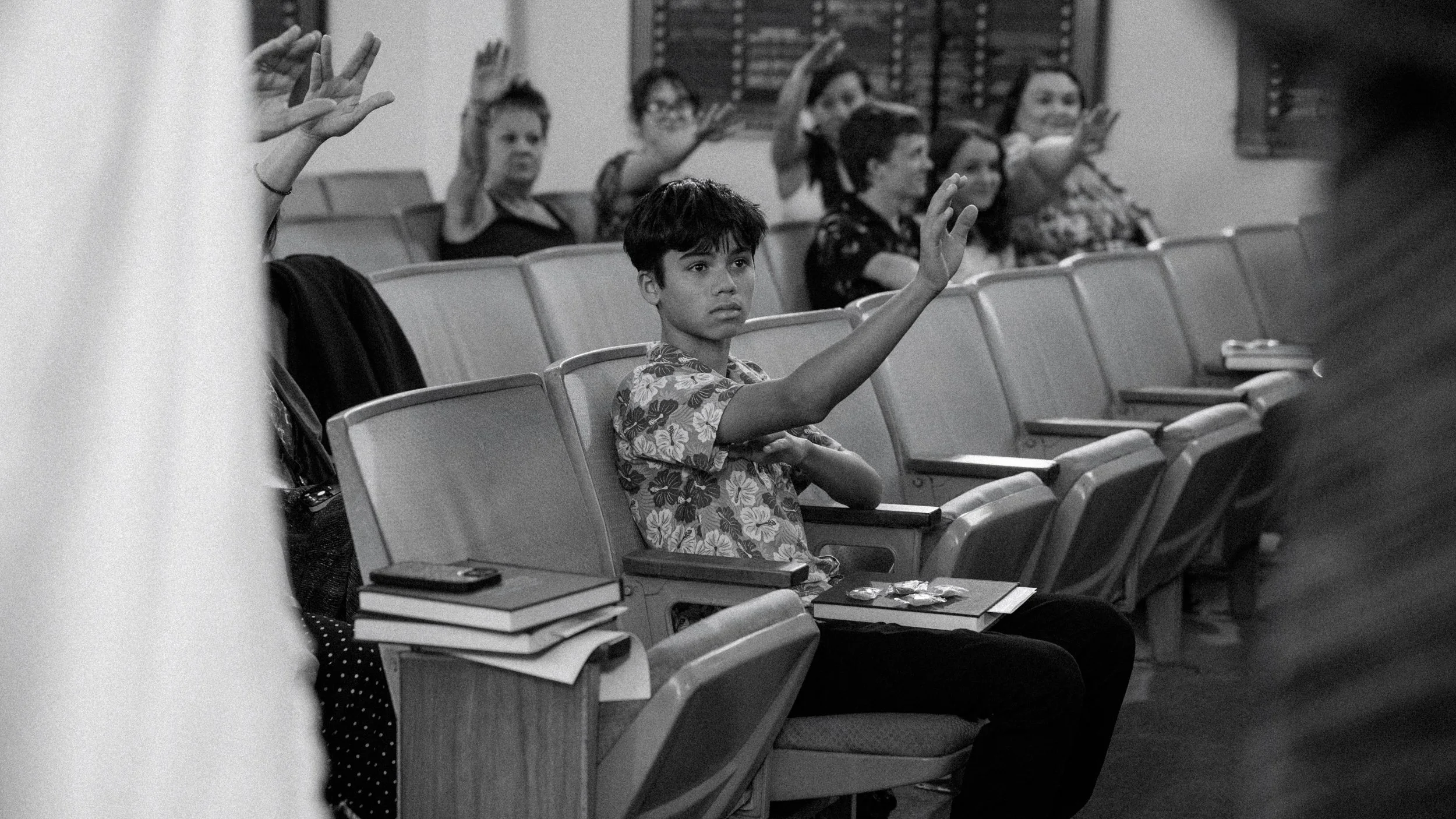 candid interaction of family members during prayer at bar mitzvah Honolulu
