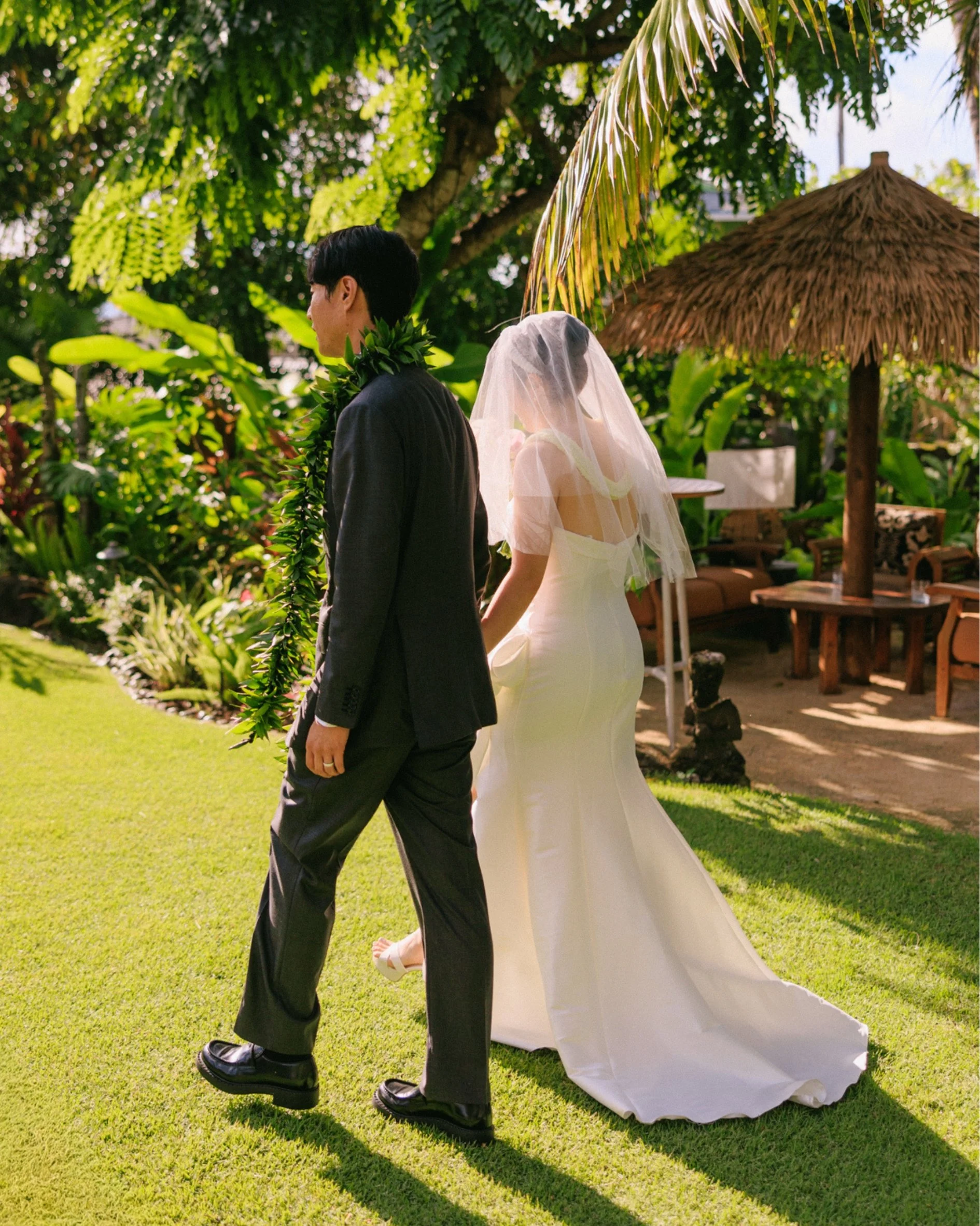 Tiffany and Sungho walking together through the tropical gardens at Male'ana Gardens in Kailua after their first kiss
