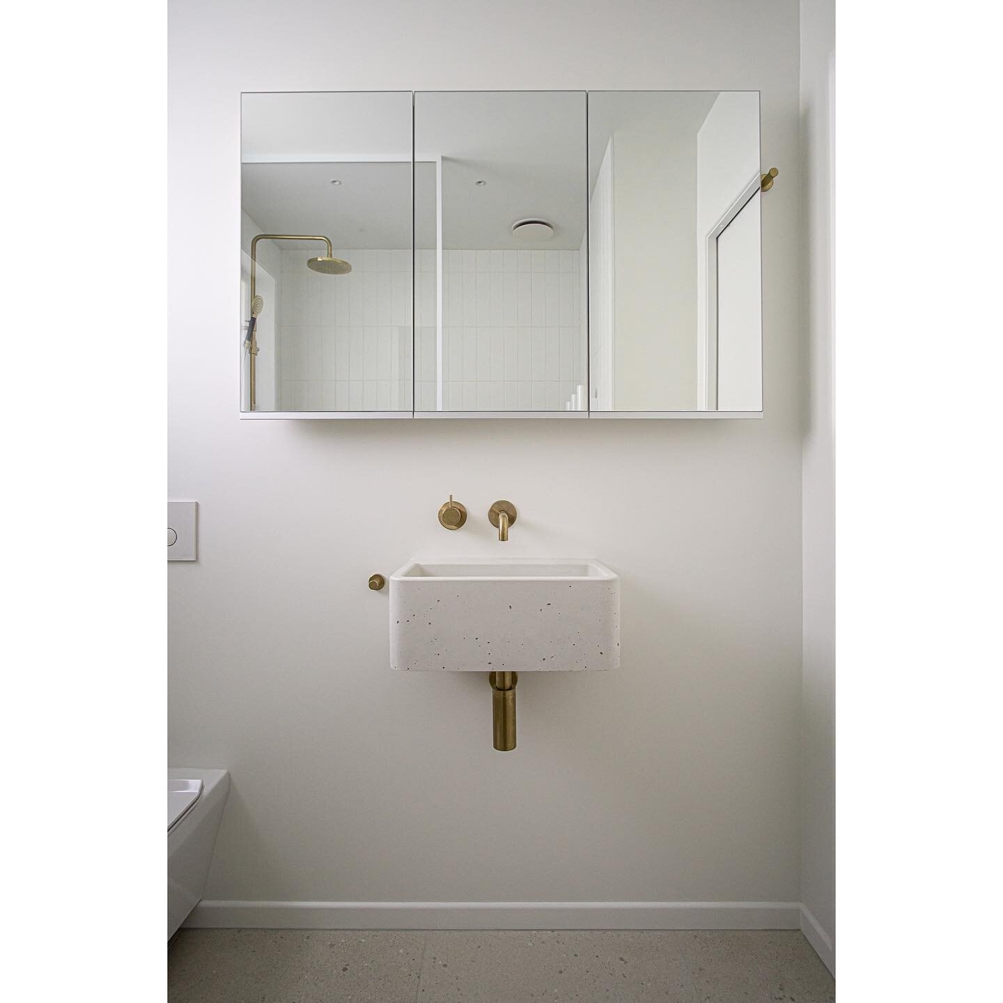 Project BUCKLEY - The white concrete basin provides a solid textural balance to this side of the bathroom while still keeping with the fresh, clean palette. While the mirror cabinet provides ample storage and creates a more open, spacious feel. 

Thi
