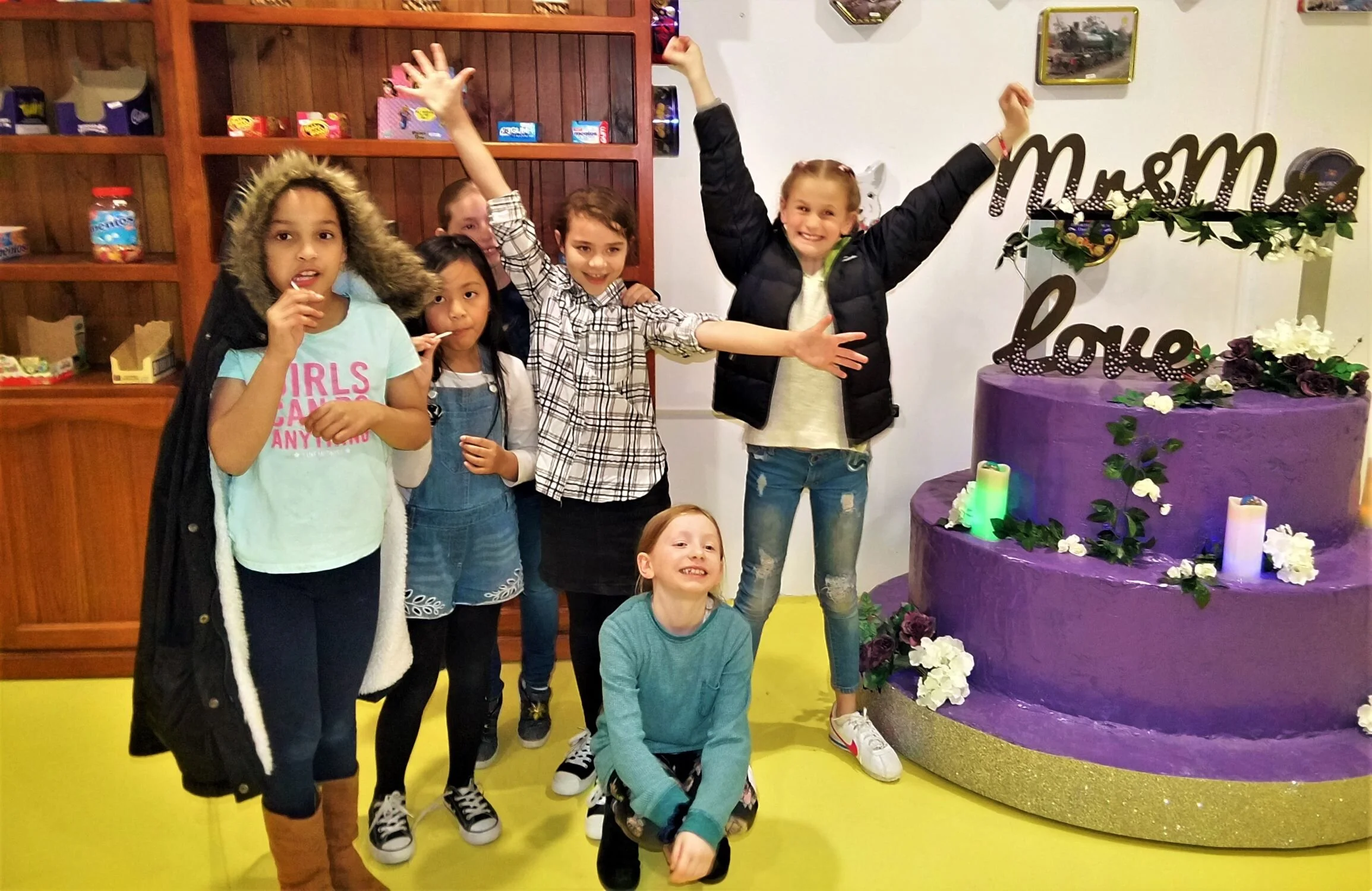 kids celebrating their win in thelolly shop escape room at dropbear escapes.