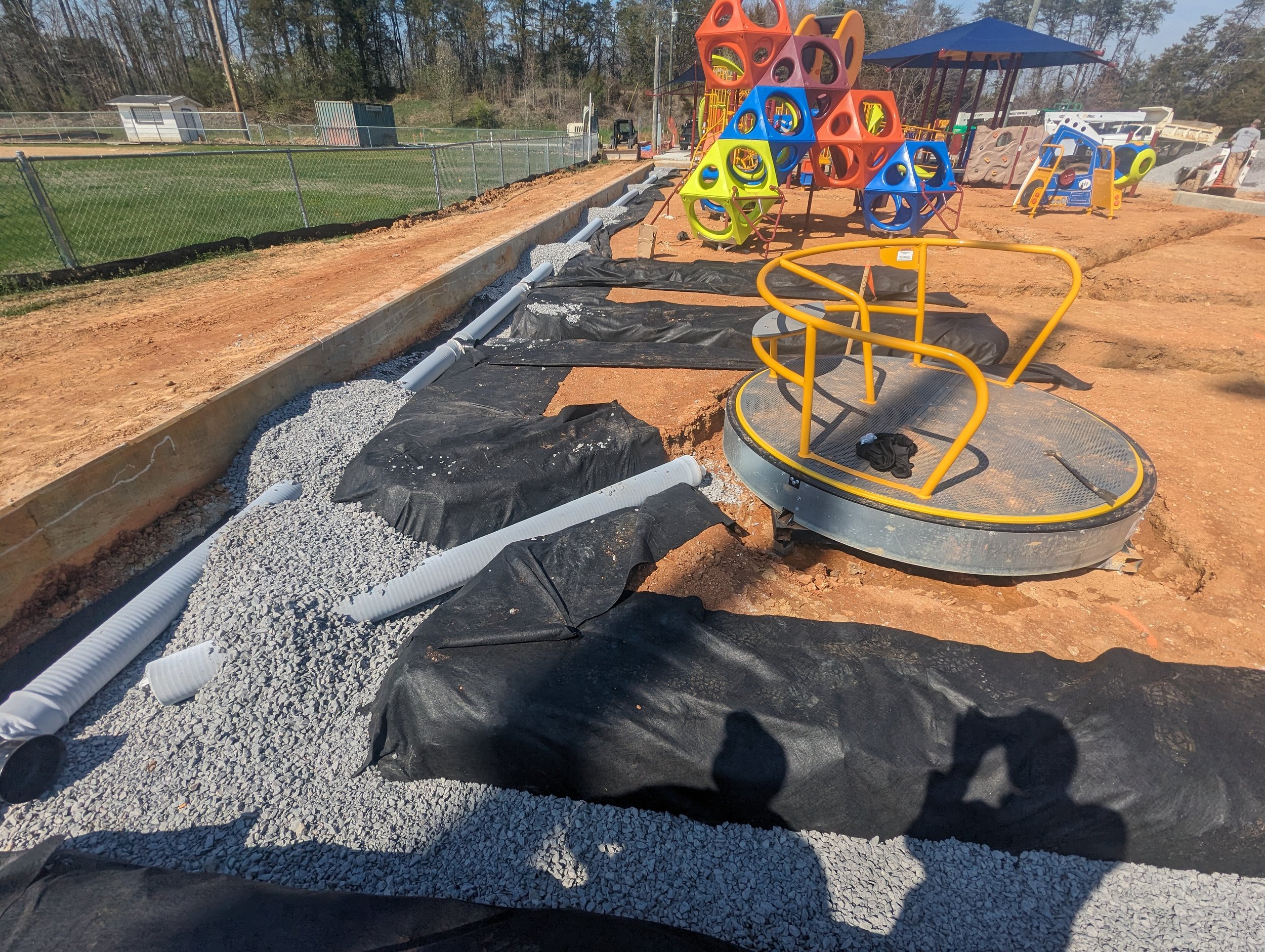 3/14/2024 - Contractors begin installing storm drainage around the playground equipment.  Drainage protects the playground surfacing from damage.