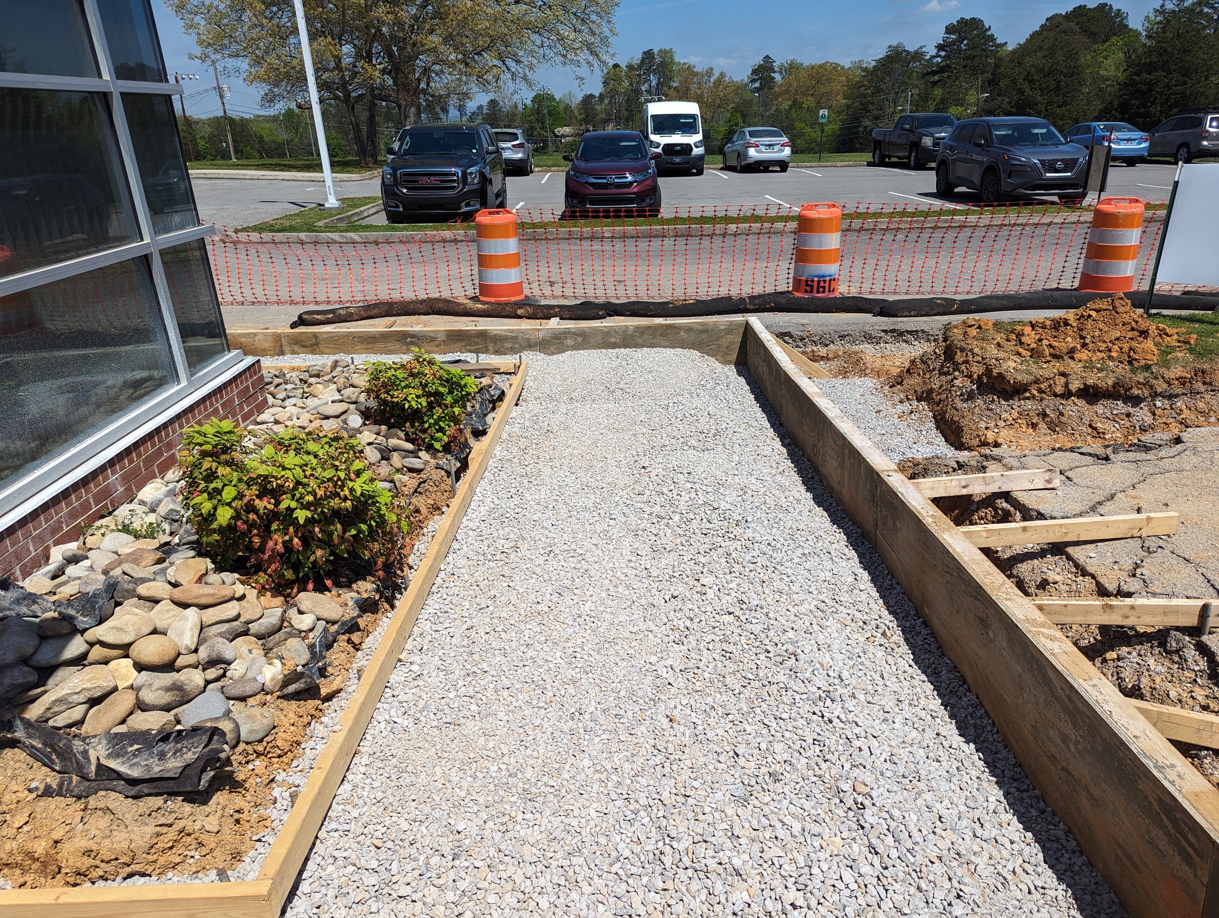 4/18/2024 - With forms complete, crews install and compact base stone and place expansion joints in preparation to pour the new sidewalks.