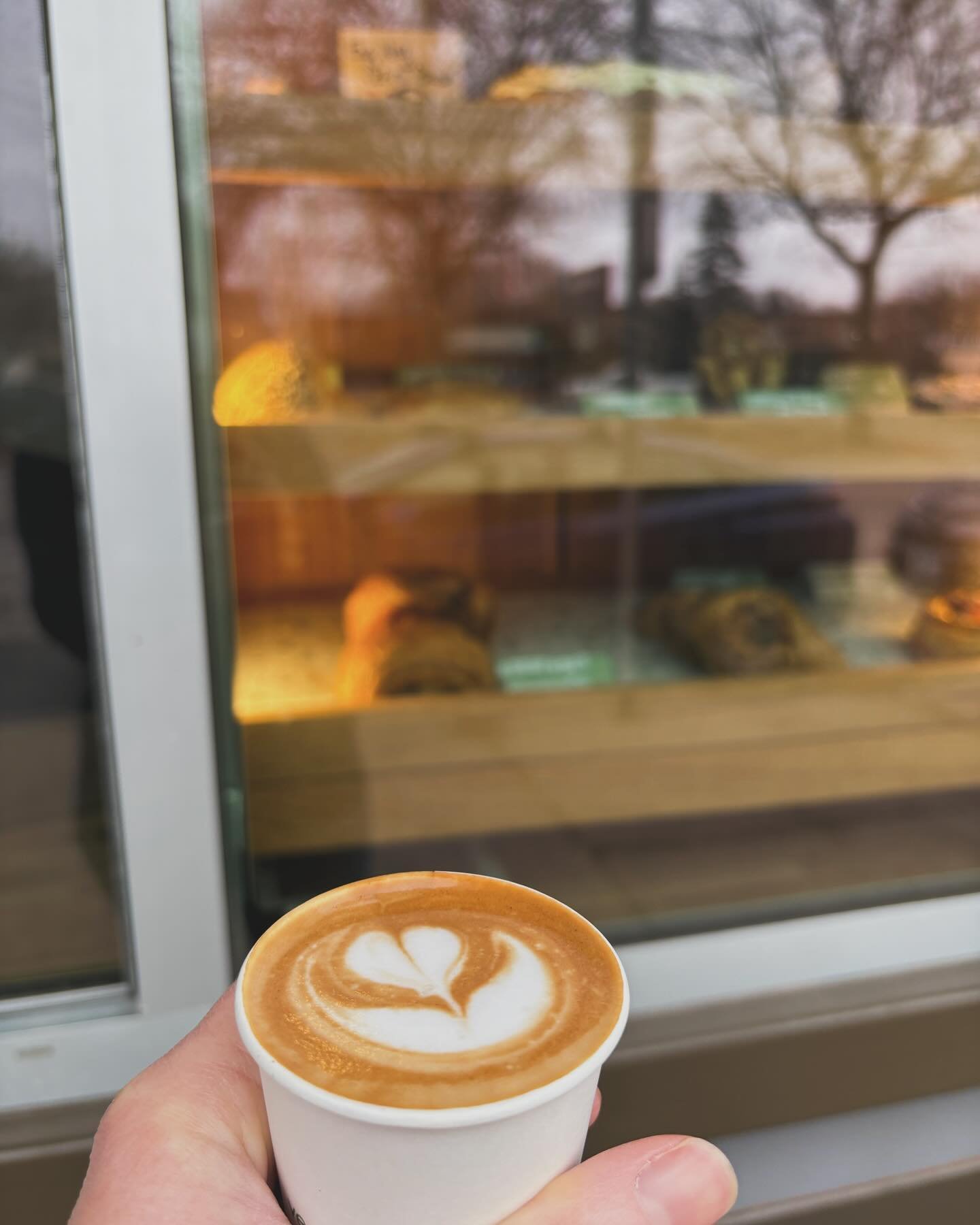 Cute little 4oz con leche is contemplating the pastry options in @vikingsandgoddesses walk up window display. 🤩 Stop by and find your perfect pairing. 🥐☕️ We&rsquo;re open Friday 7-12 (pastries start at 8!) and Sunday 8-12. If you want to order bea