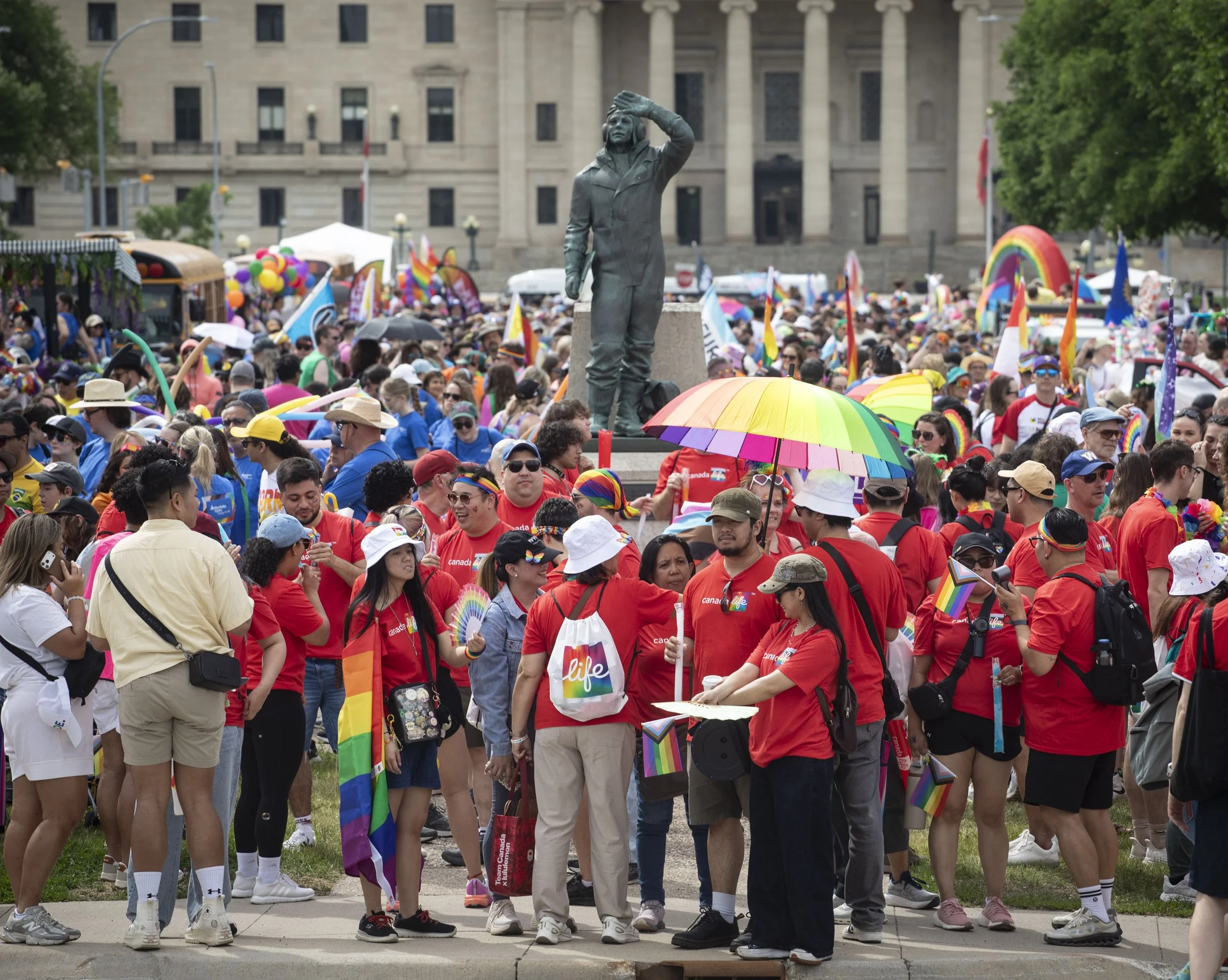 Participants in the 2026 Winnipeg Pride Parade gather near the Legislative Building before the start of their march.