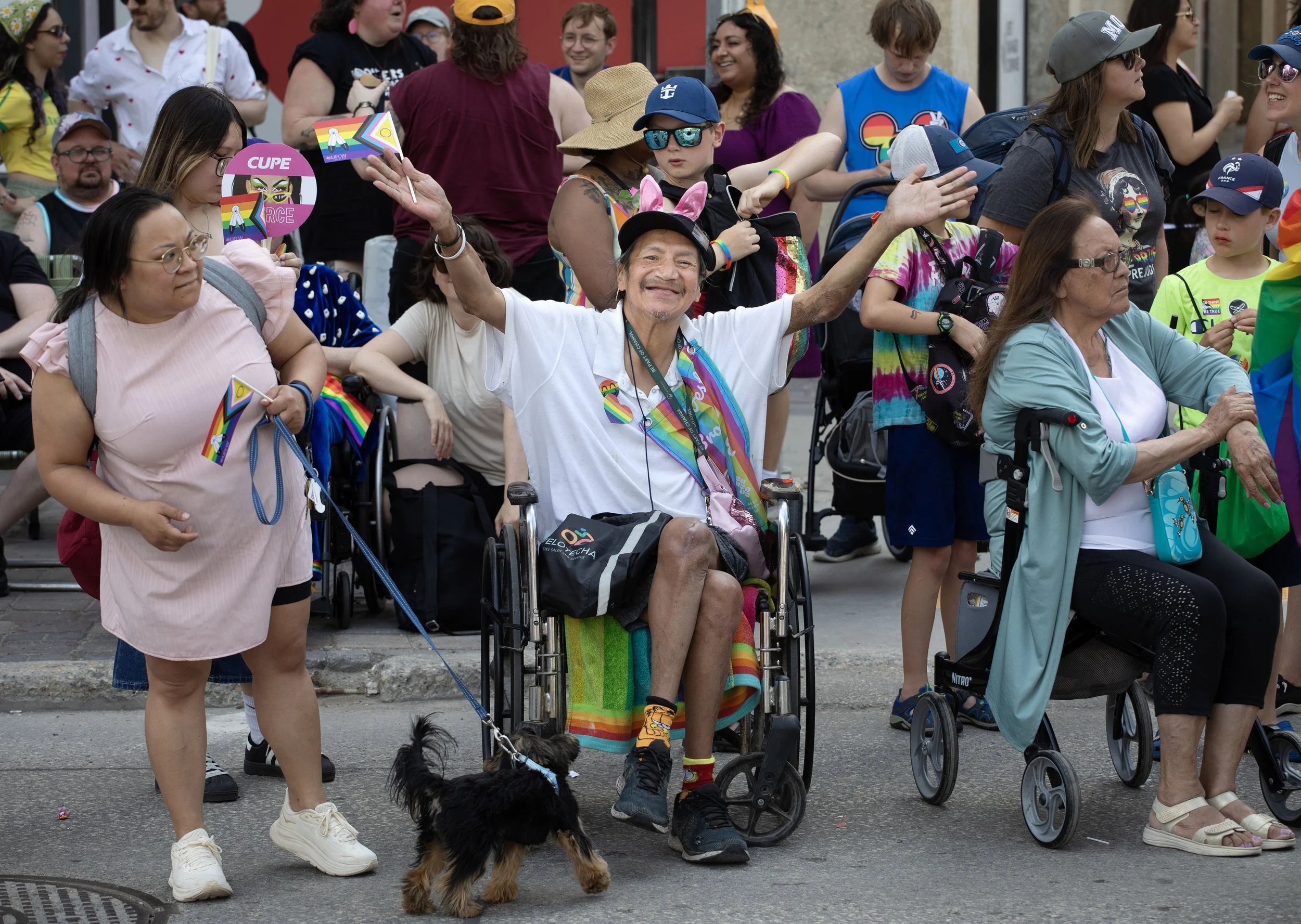 A beaming onlooker offers a smile and a wave during the 2026 Winnipeg Pride Parade.