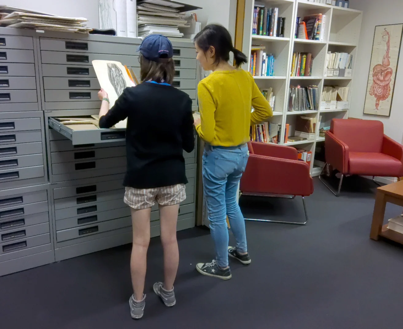 BMC students Colleen Tang Poy and Jenny Chin look through archival material in the Elizabeth Blackstock Library.