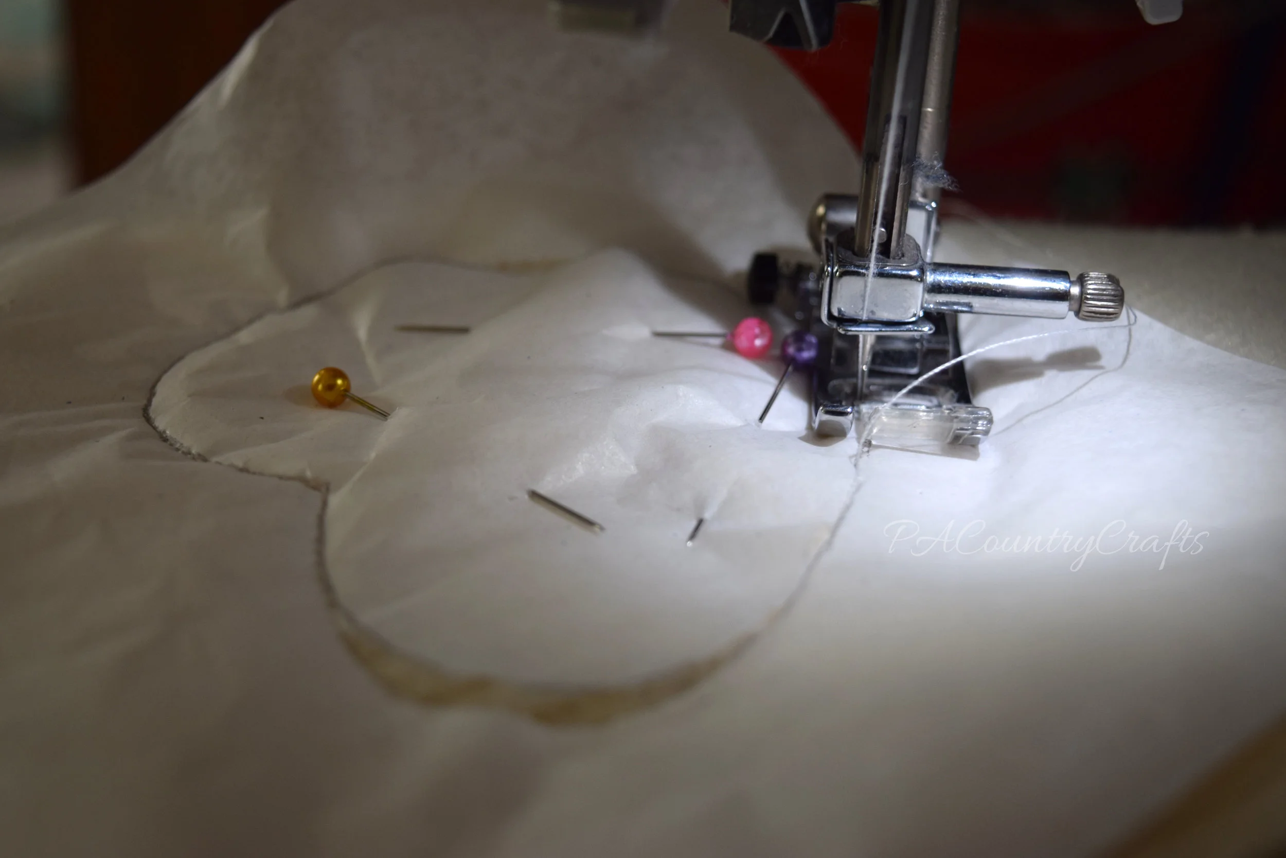 How to sew through tissue paper onto sweaters