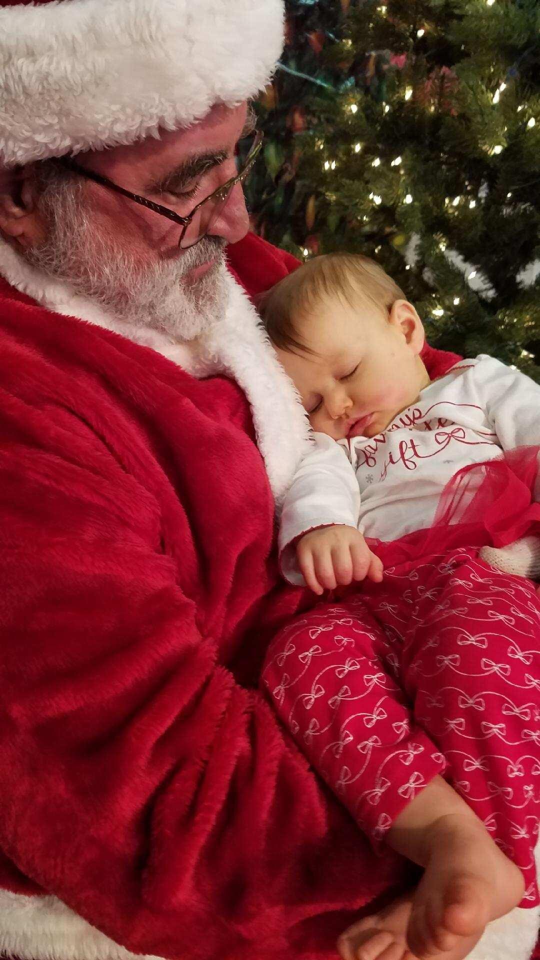 Troop 716 Santa with a sleeping baby.jpeg