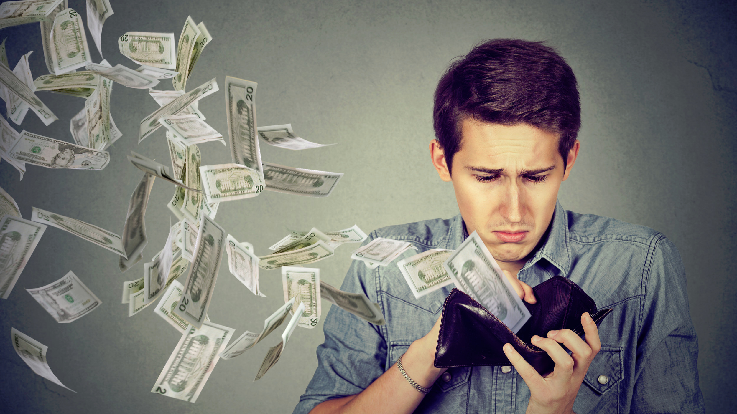 Canva+-+Man+looking+at+wallet+with+money+dollars+flying+away.jpg